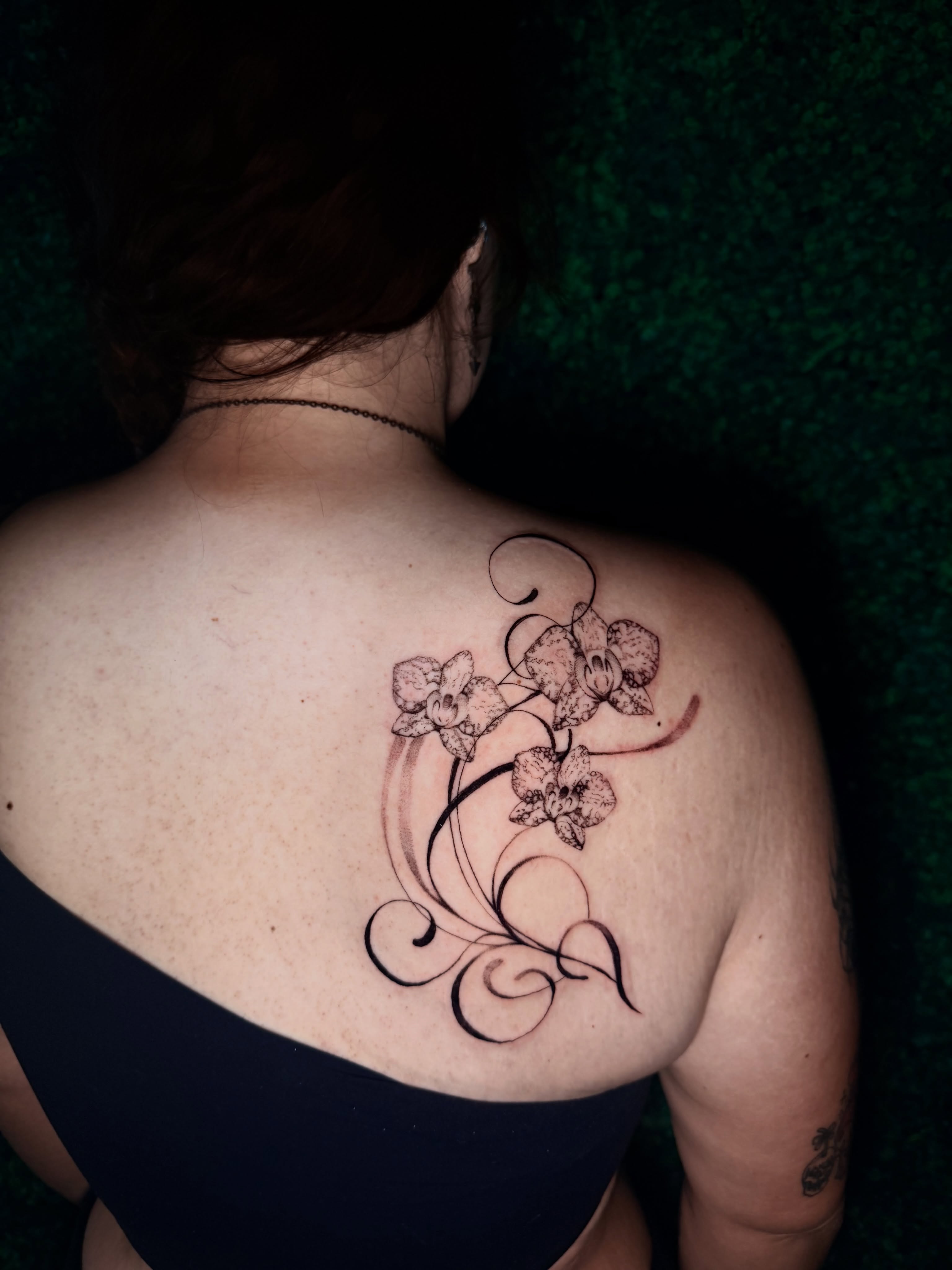 Orchid and swirls black and grey tattoo on the back by bella :)