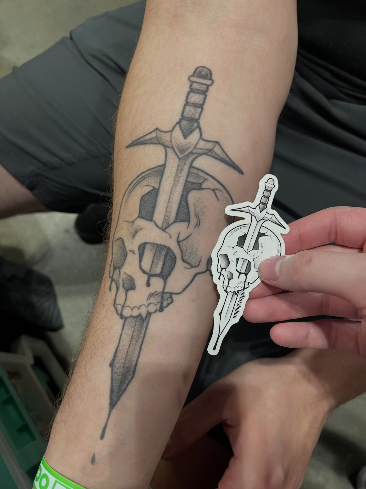 Sword through skull black and grey tattoo on the forearm by bunny, Minneapolis, Minnesota