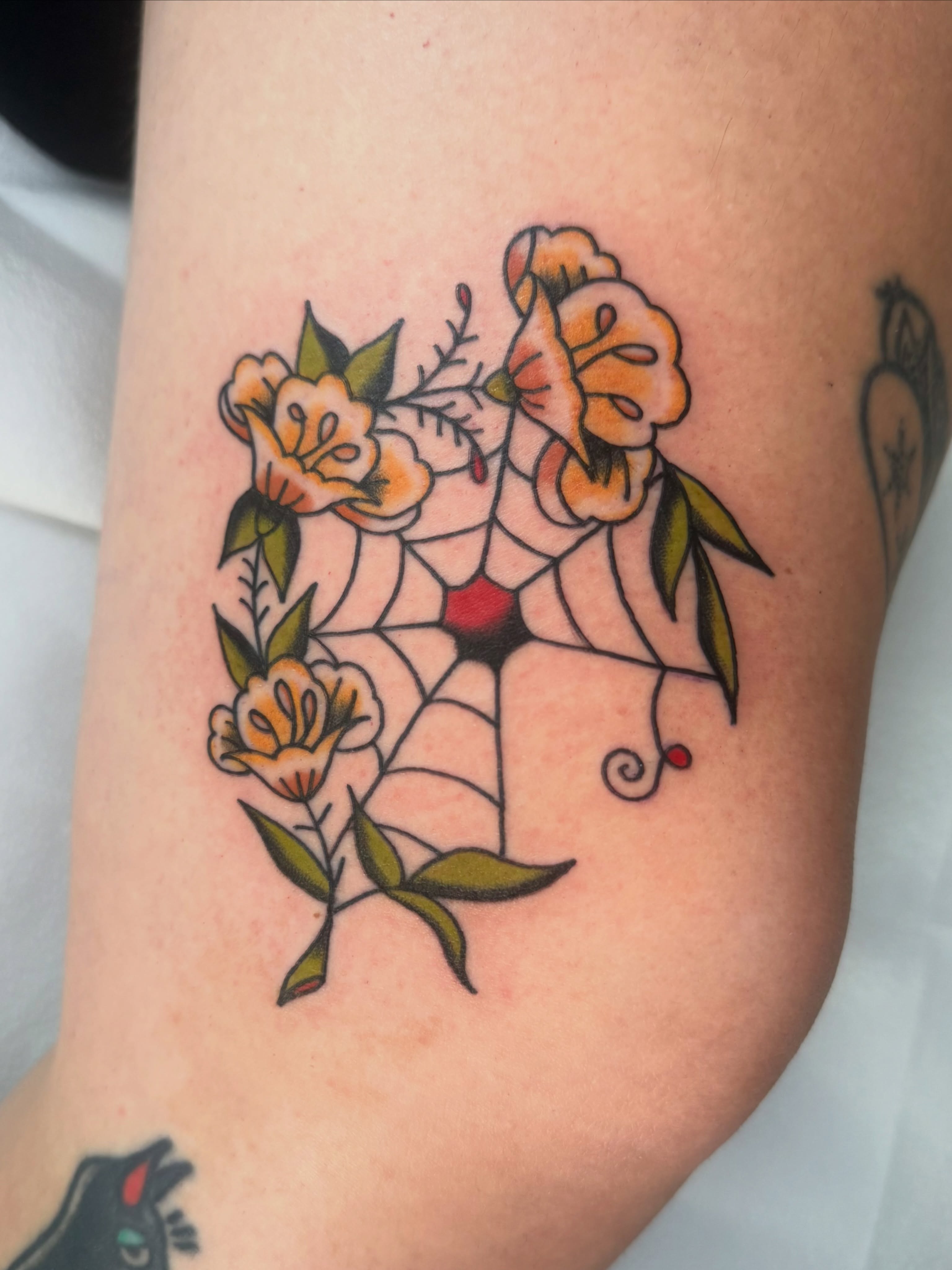 Spiderweb with flowers American traditional tattoo on the forearm by Lexie Graff