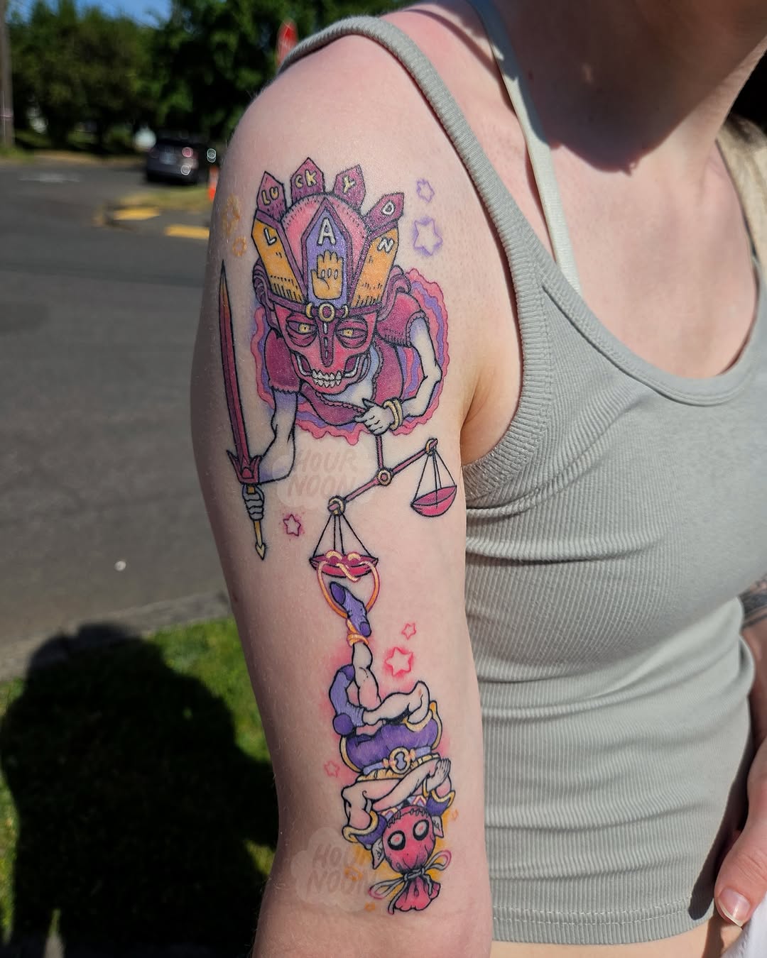 Jester and scales new school tattoo on the forearm by 𝖍𝖔𝖚𝖗𝖓𝖔𝖔𝖓