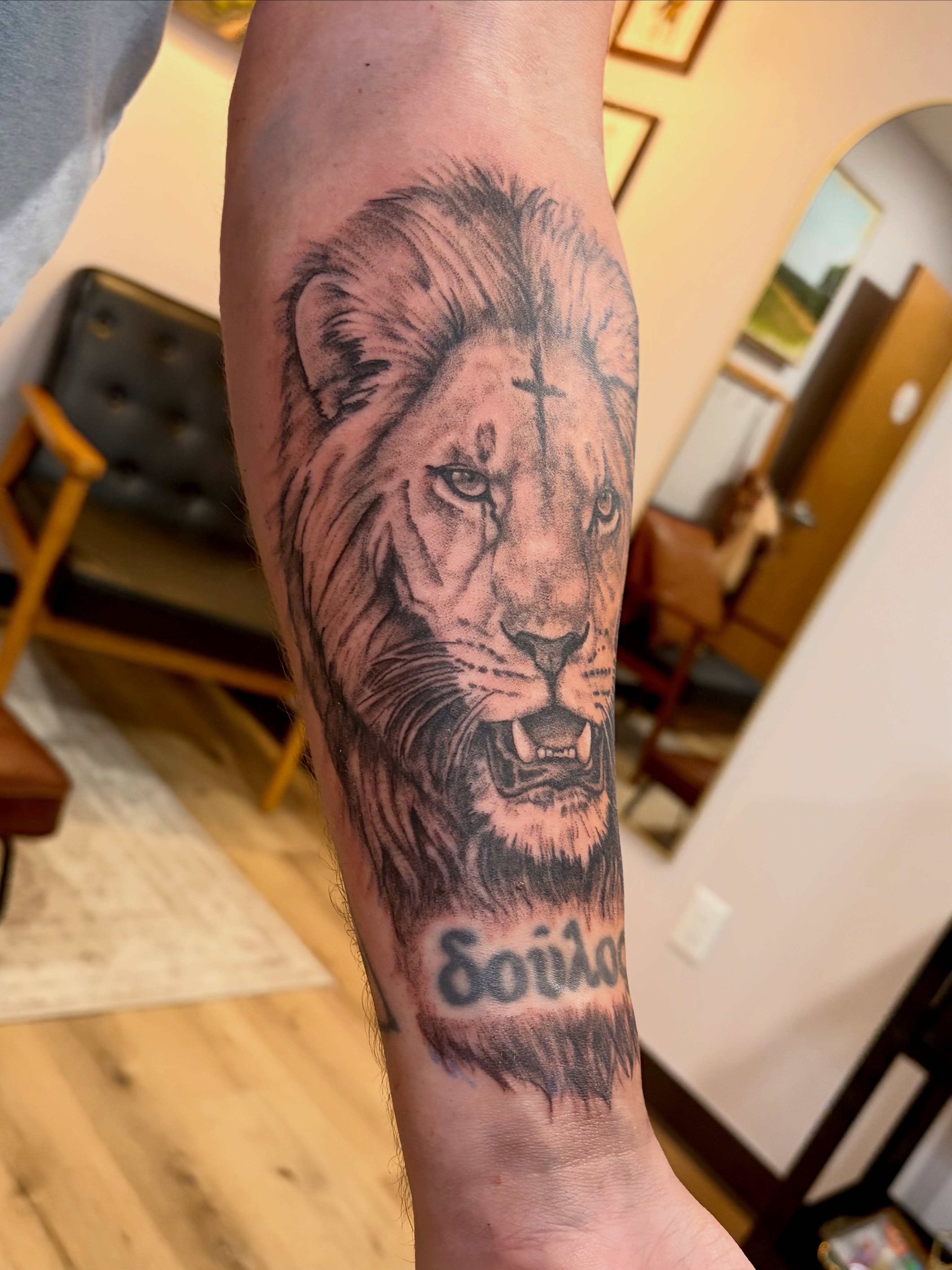 Lion realism tattoo on the forearm by Emily, Monticello, Iowa