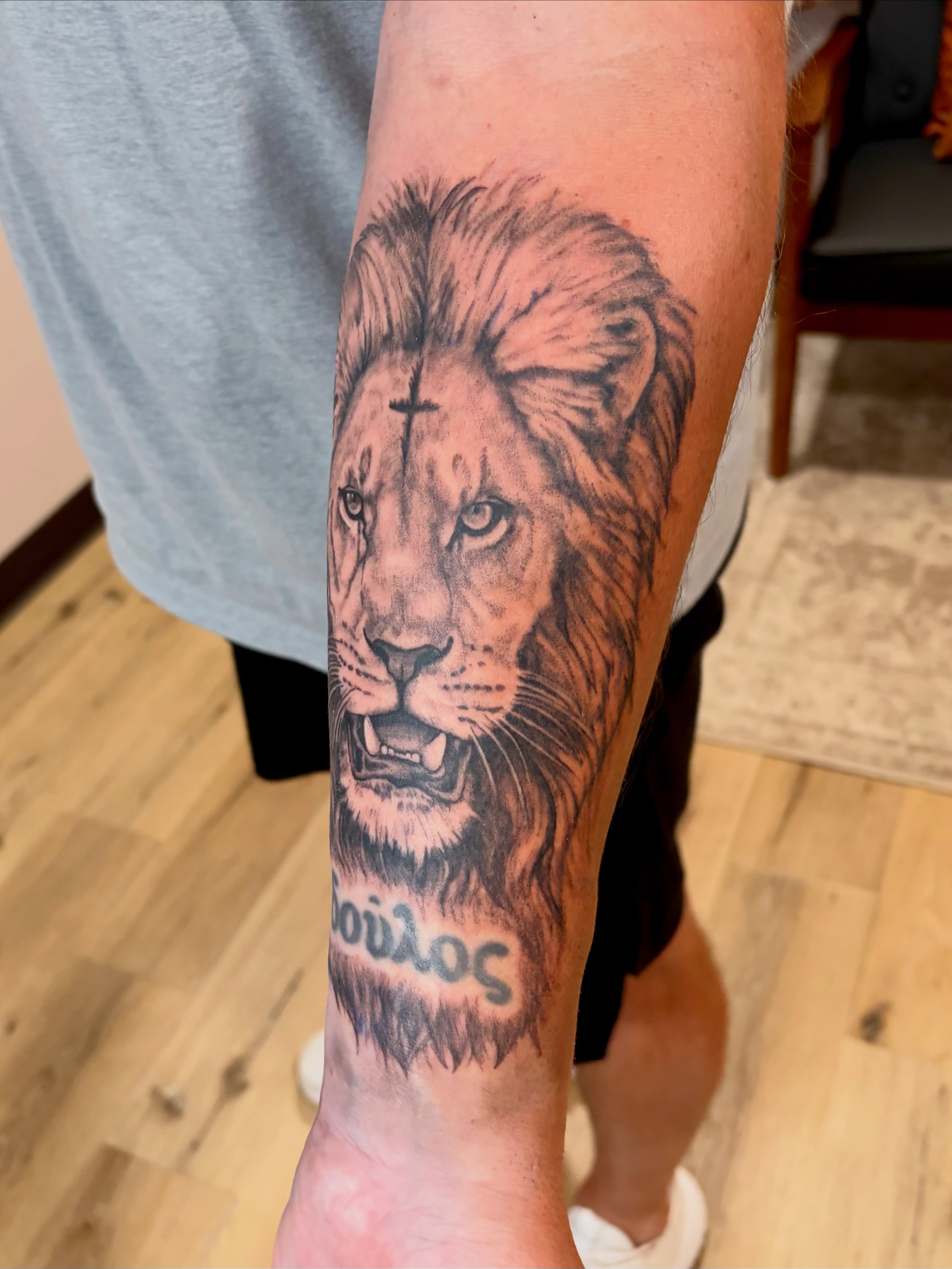 Lion realism tattoo on the forearm by Emily, Monticello, Iowa