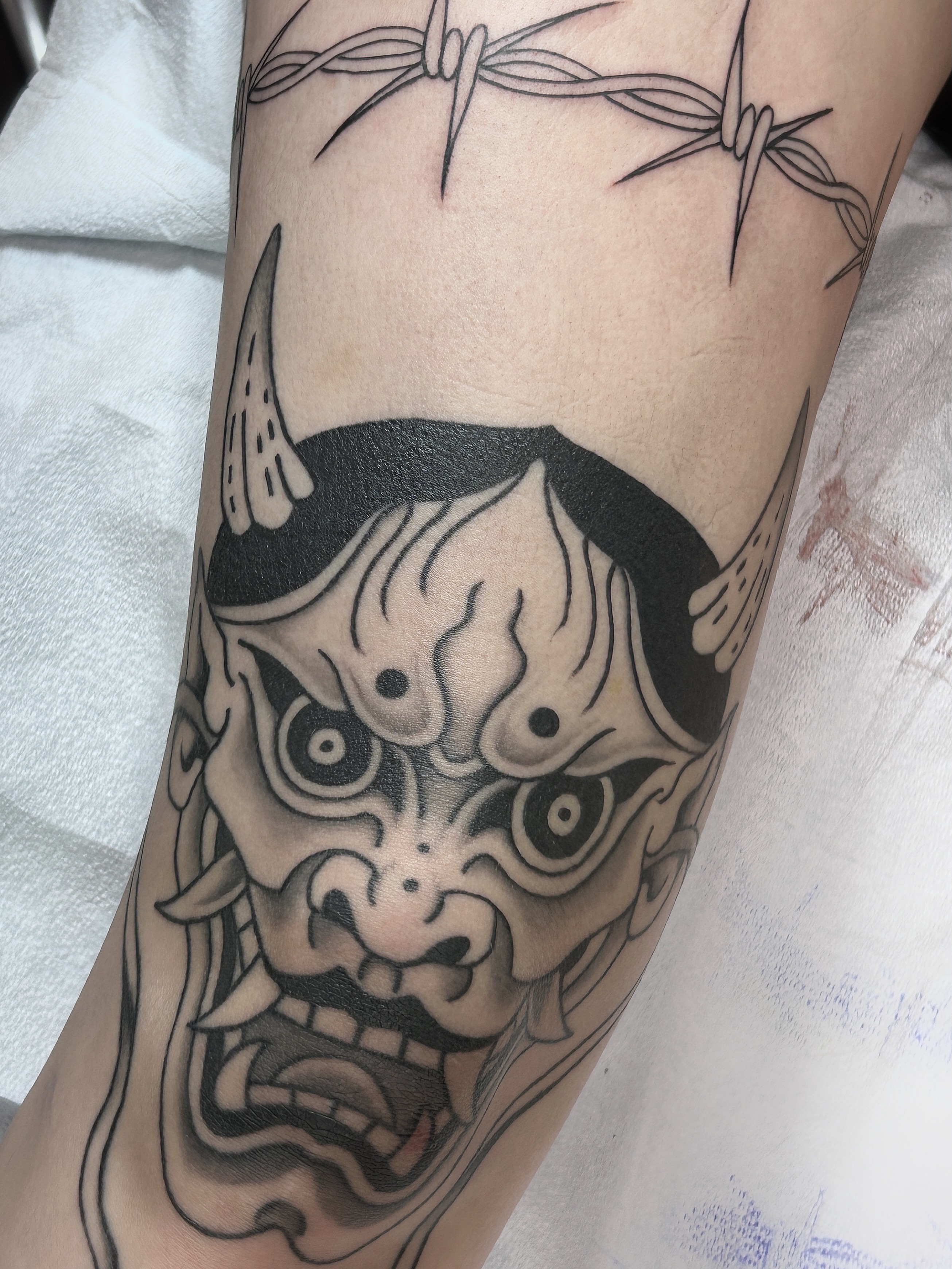 Demon mask black and grey tattoo on the forearm by holly danesi . philadelphia tattoo, Philadelphia, Pennsylvania