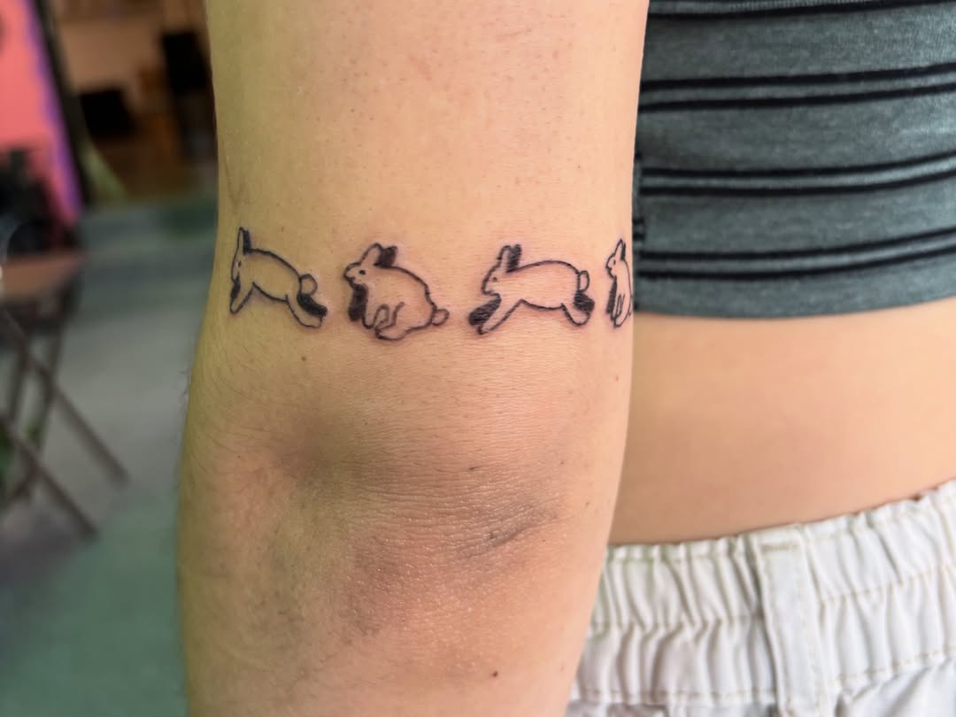 Rabbits black and grey tattoo on the forearm by Hiro Robinson