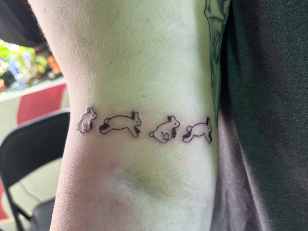 Rabbits black and grey tattoo on the forearm by Hiro Robinson