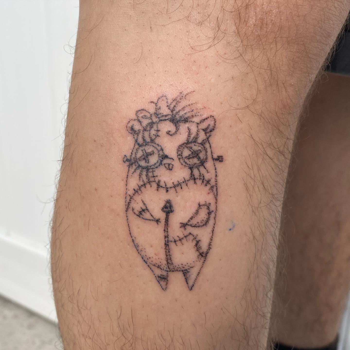 Stitched creature minimalist tattoo on the forearm by @feverfeverish