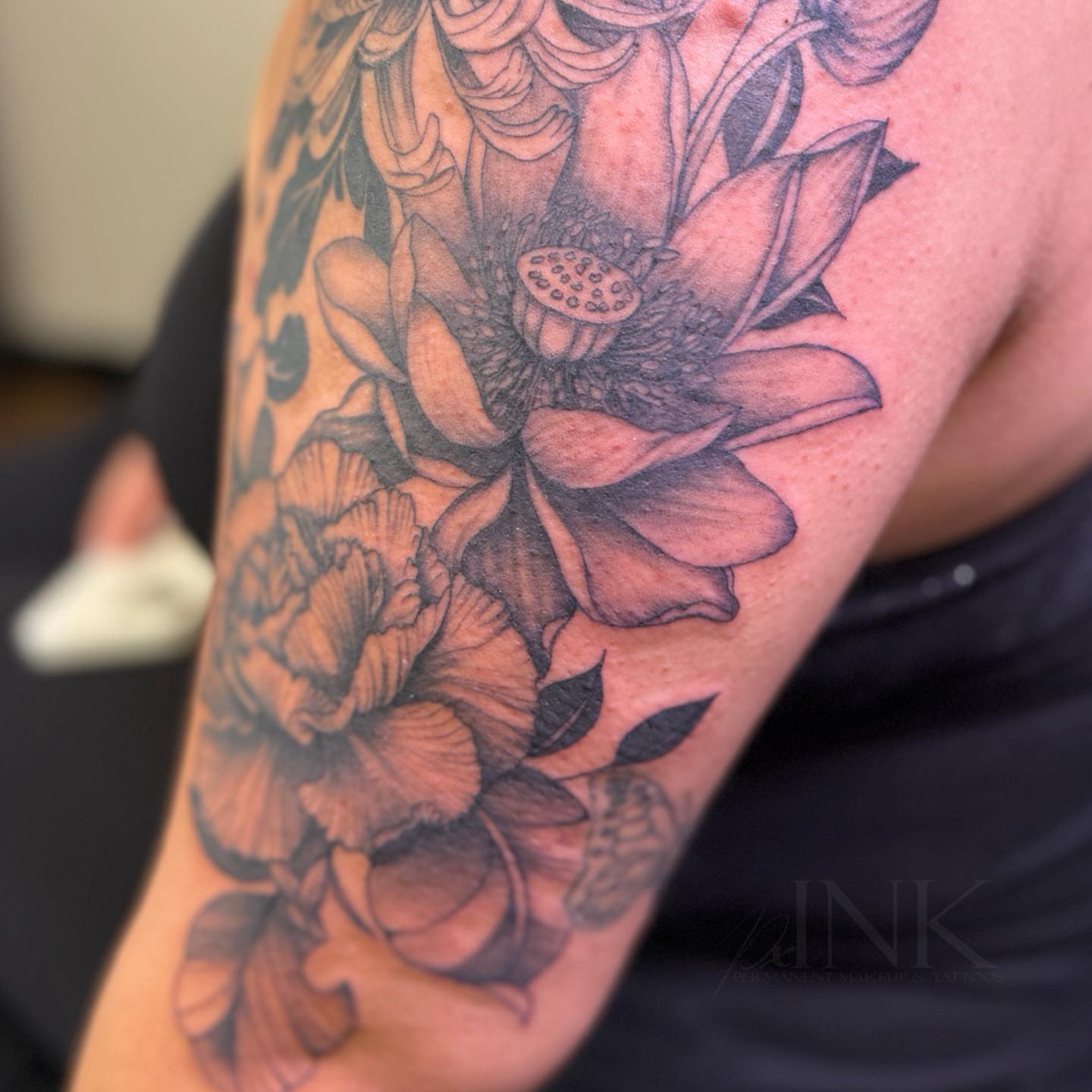 Lotus flowers black and grey tattoo on the forearm by PxINK, Crystal, Minnesota