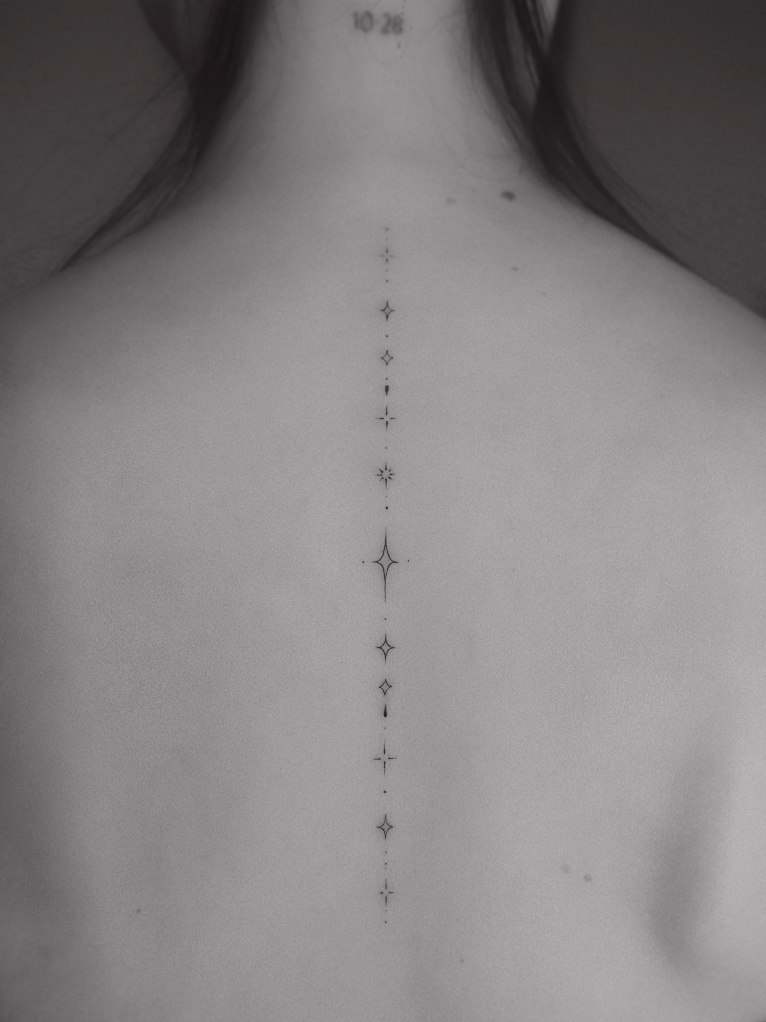 Dots and stars dotwork tattoo on the back by Victoria