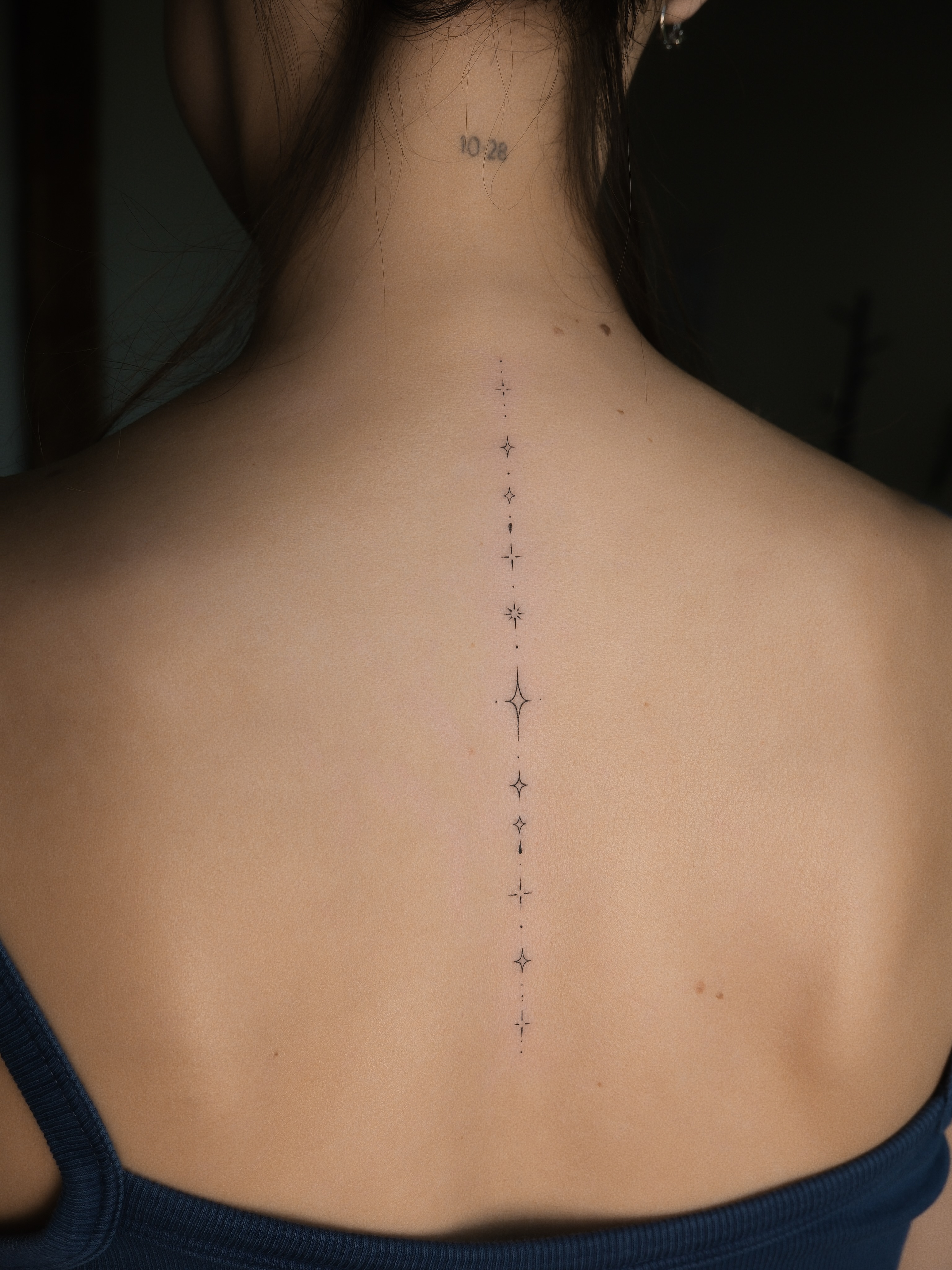 Dots and stars dotwork tattoo on the back by Victoria