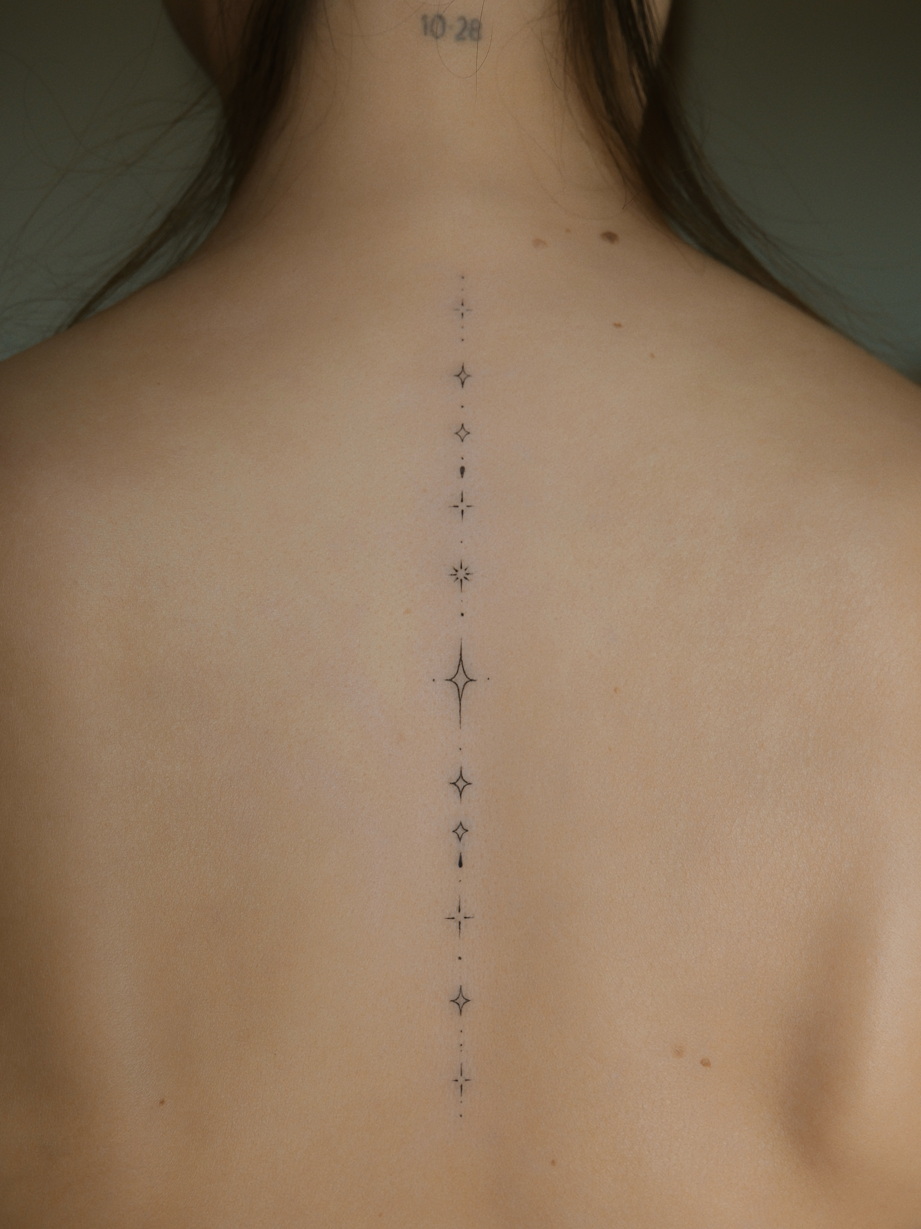Spine stars dotwork tattoo on the back by Victoria