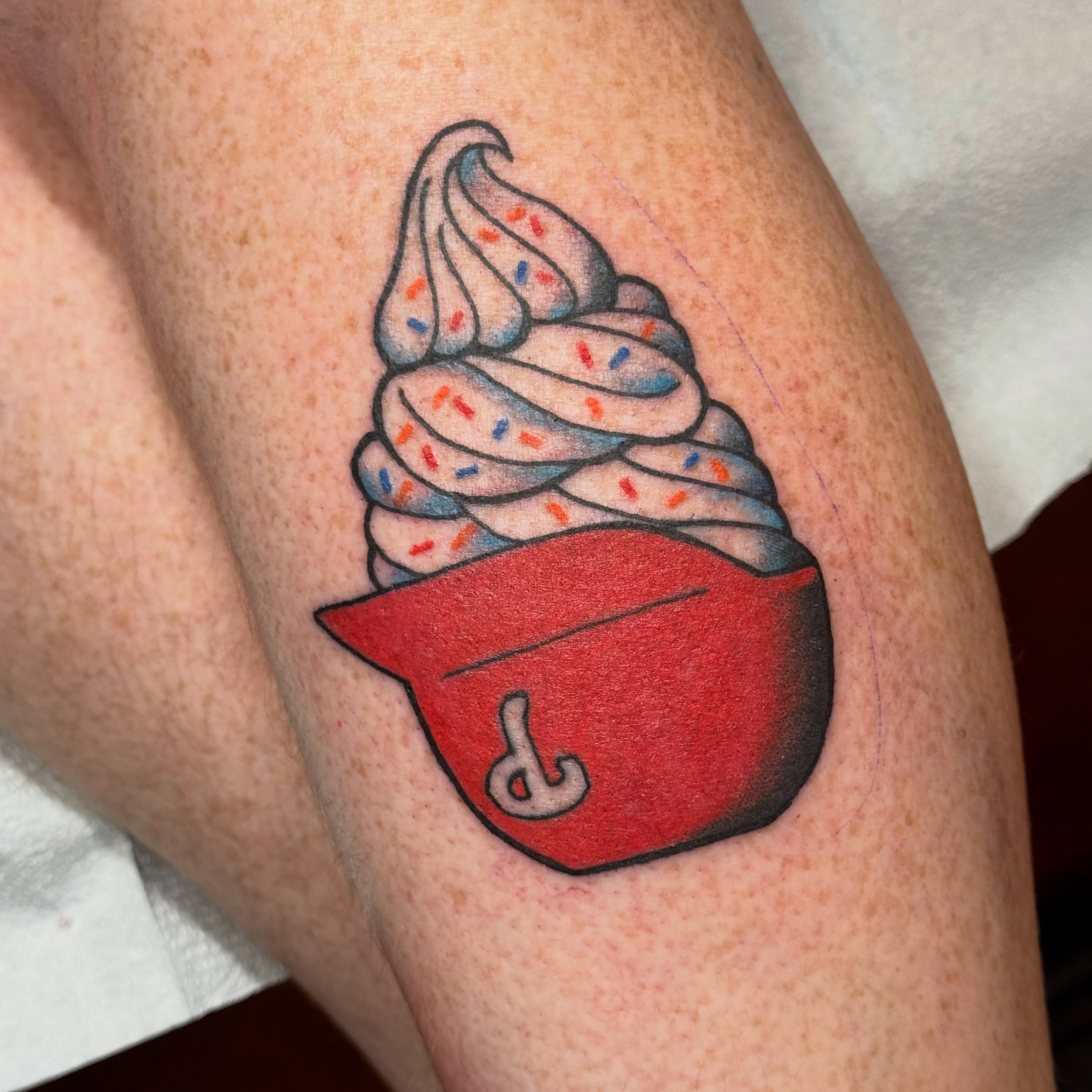 Soft serve ice cream cone realism tattoo on the forearm by Jack Hatchet Tattoos