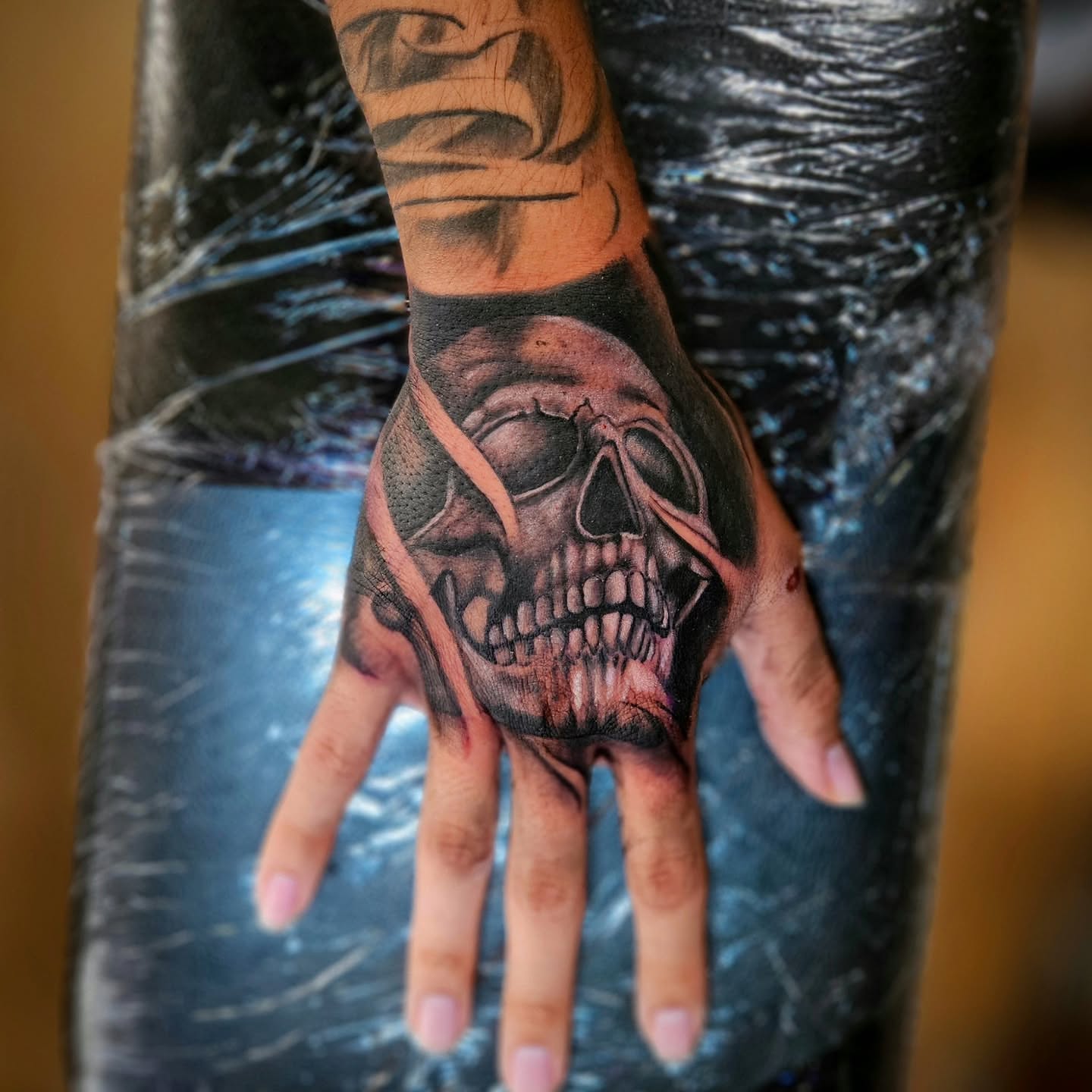 Skull realism tattoo on the hand by Justin J-rust Smith