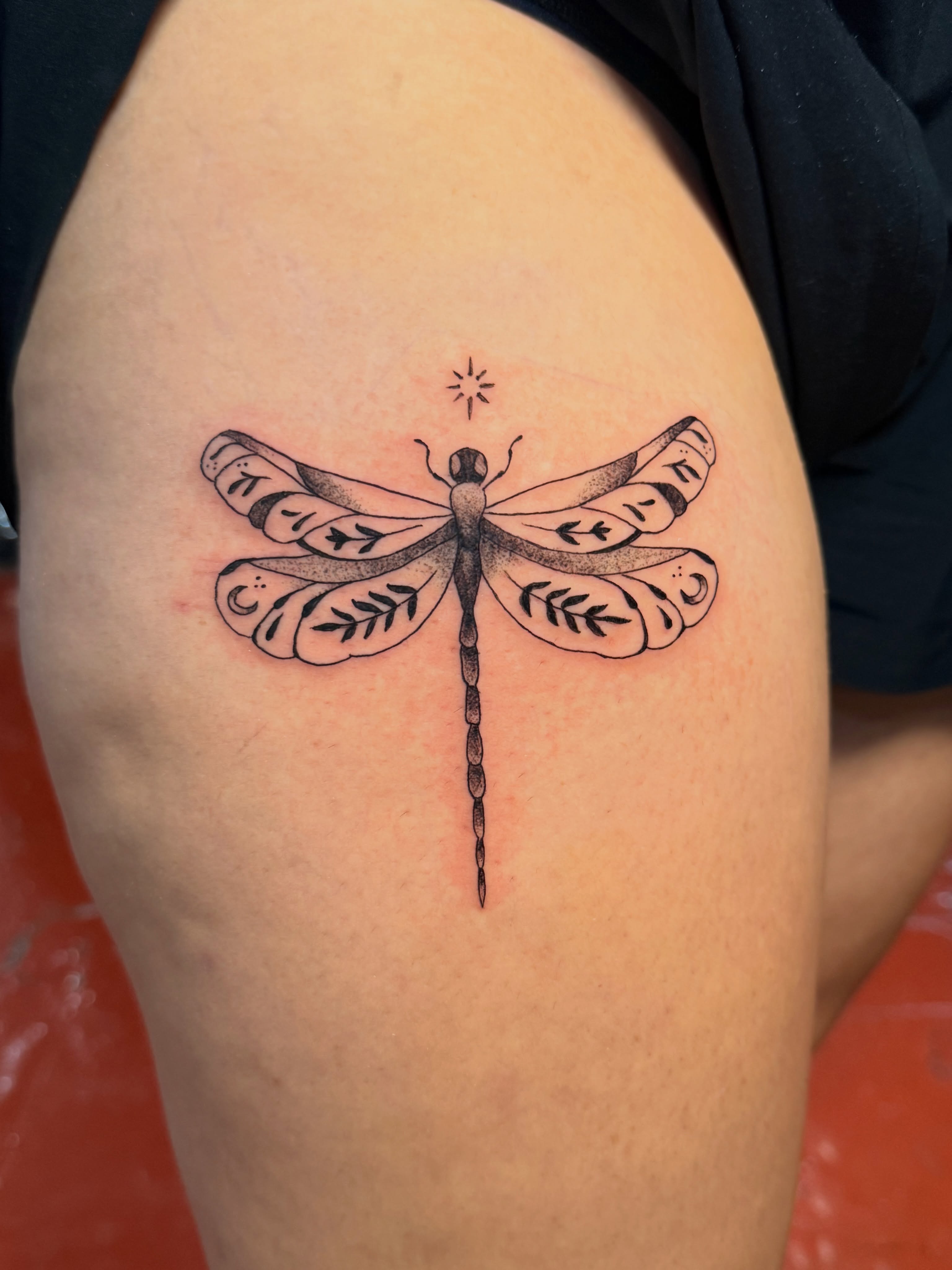 Dragonfly black and grey tattoo on the thigh by Andre Guerra