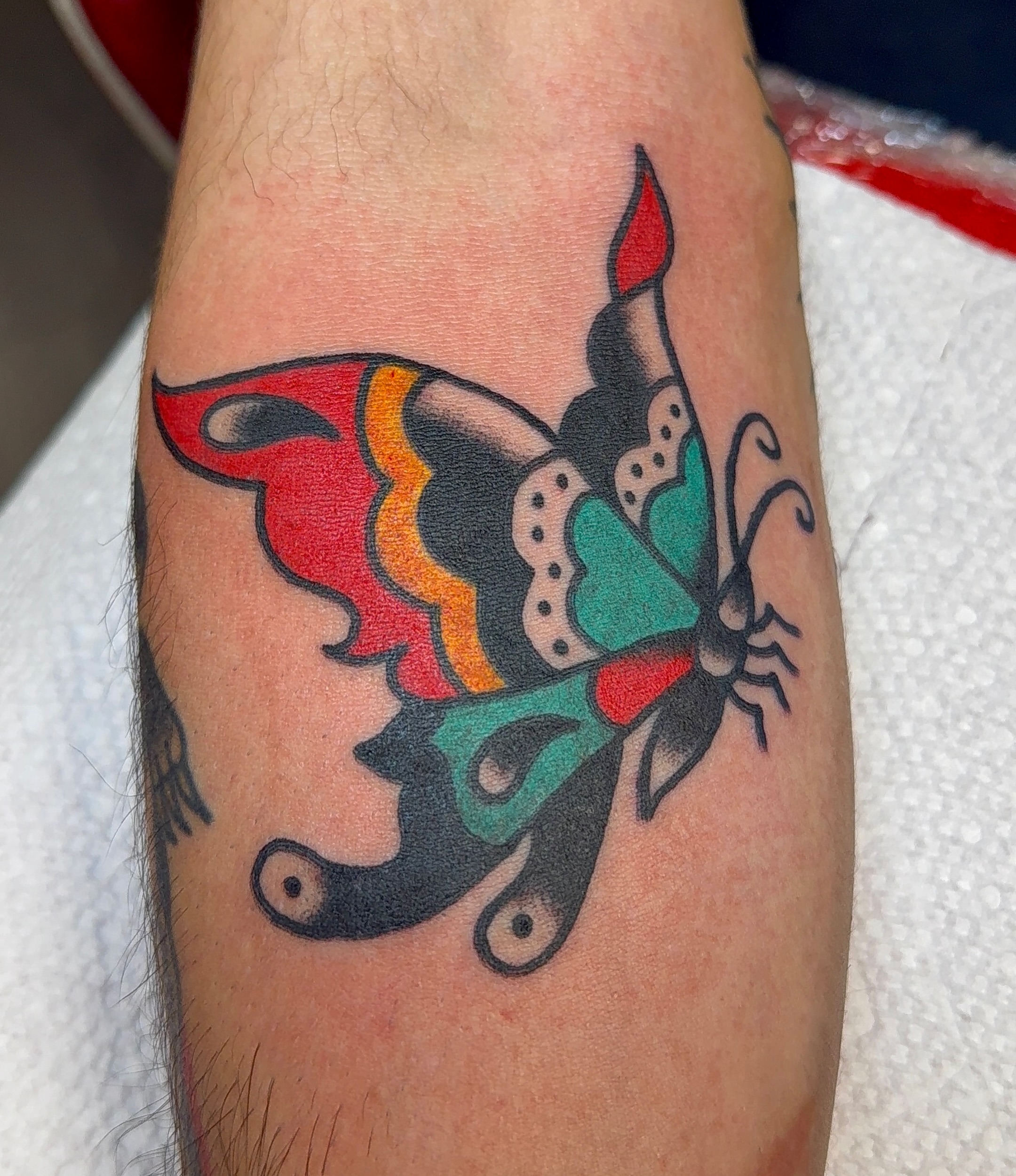 Butterfly American traditional tattoo on the forearm by VAY