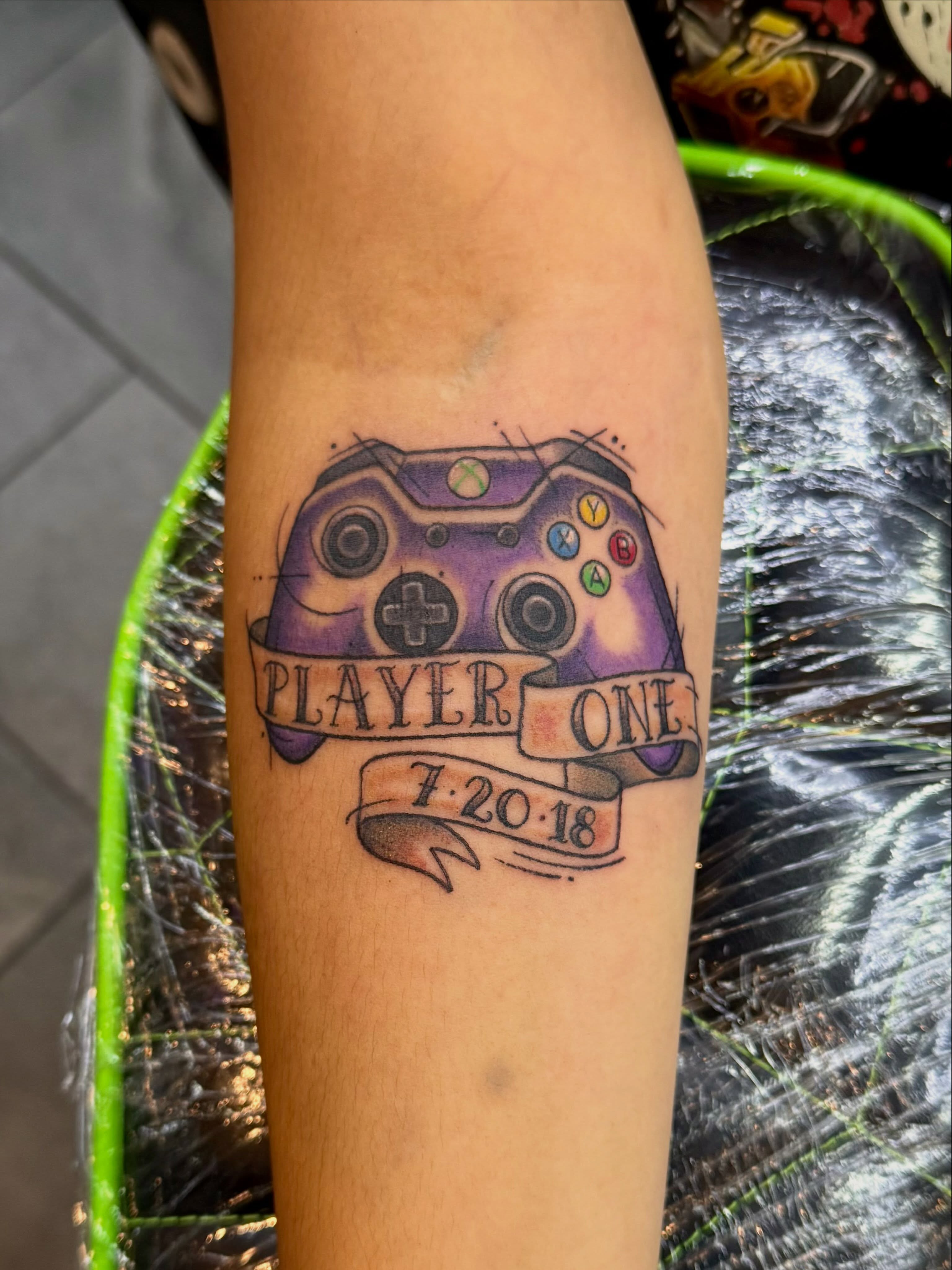 Xbox controller realism tattoo on the forearm by Ashley Kayser