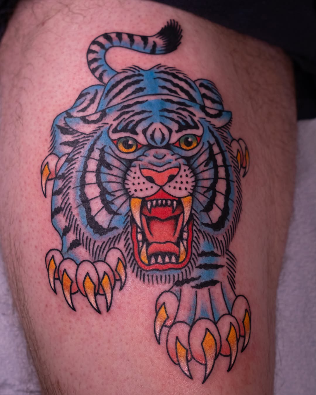 Tiger American traditional tattoo on the thigh by Justin Rakowski