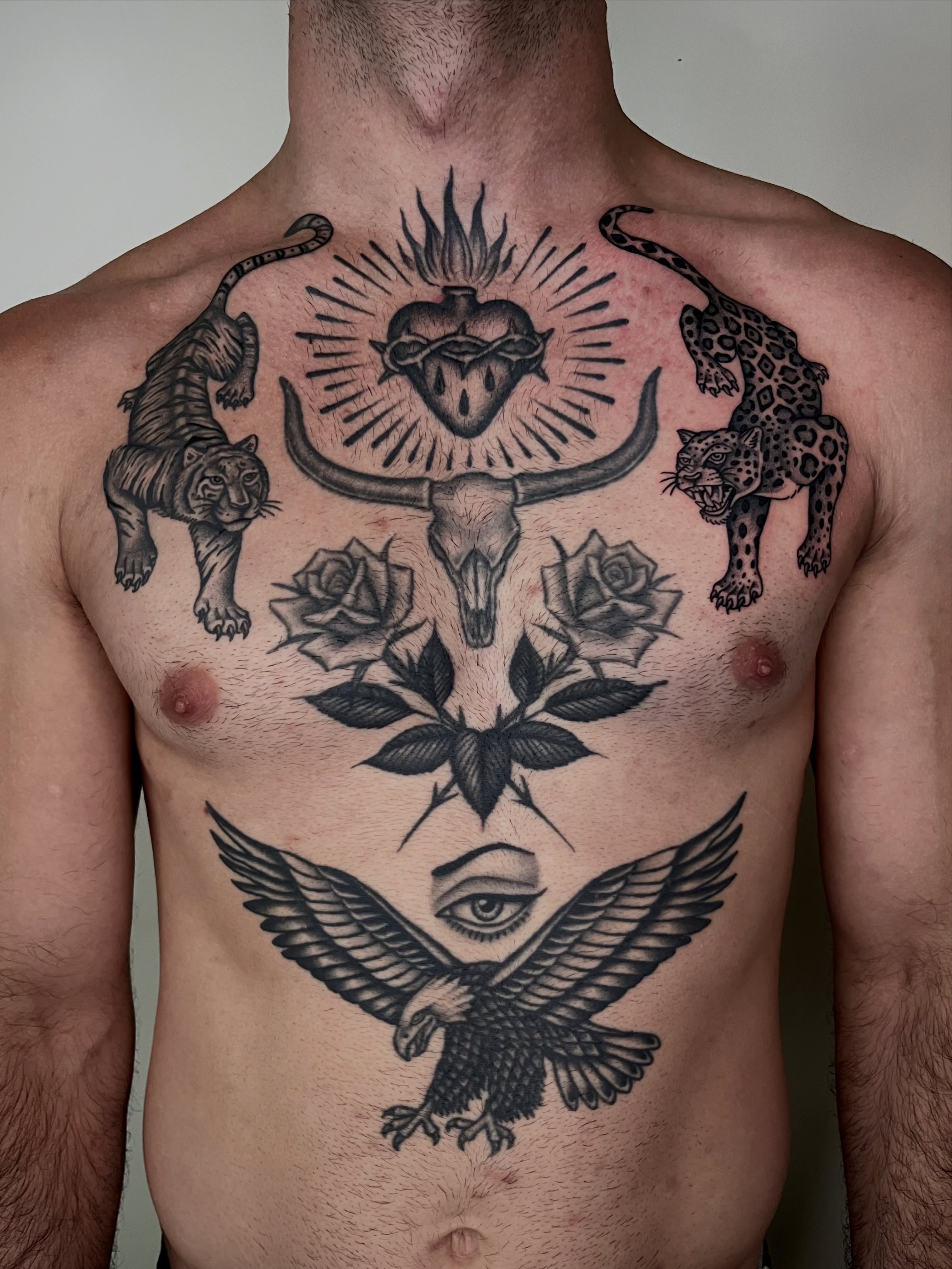 Heart with horns and animals black and grey tattoo on the chest by Patrick Elijah