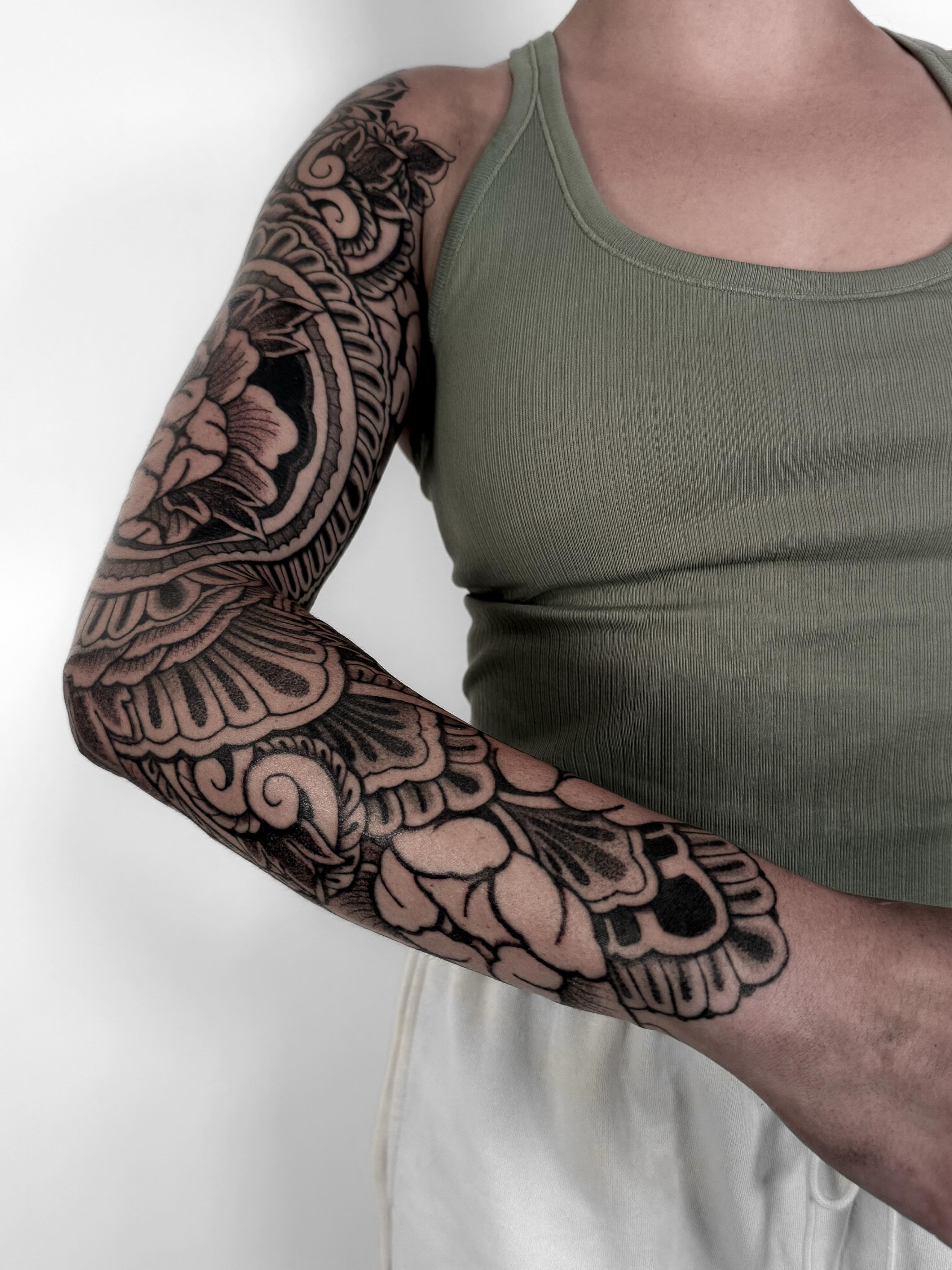 Floral design black and grey tattoo on the upper arm by Jamie Beach, Wheat Ridge, Colorado