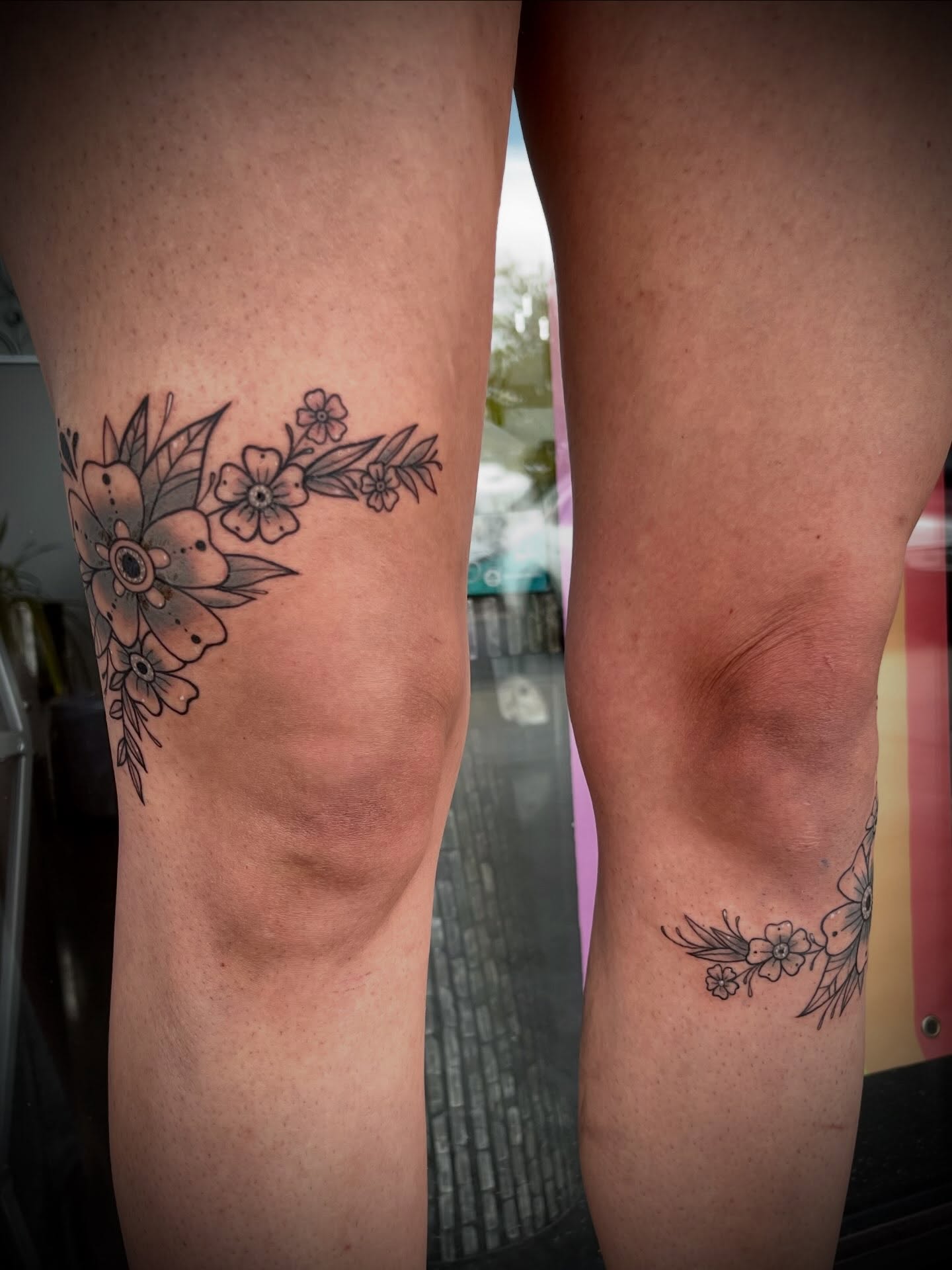 Floral arrangement black and grey tattoo on the leg by Freya Petersen