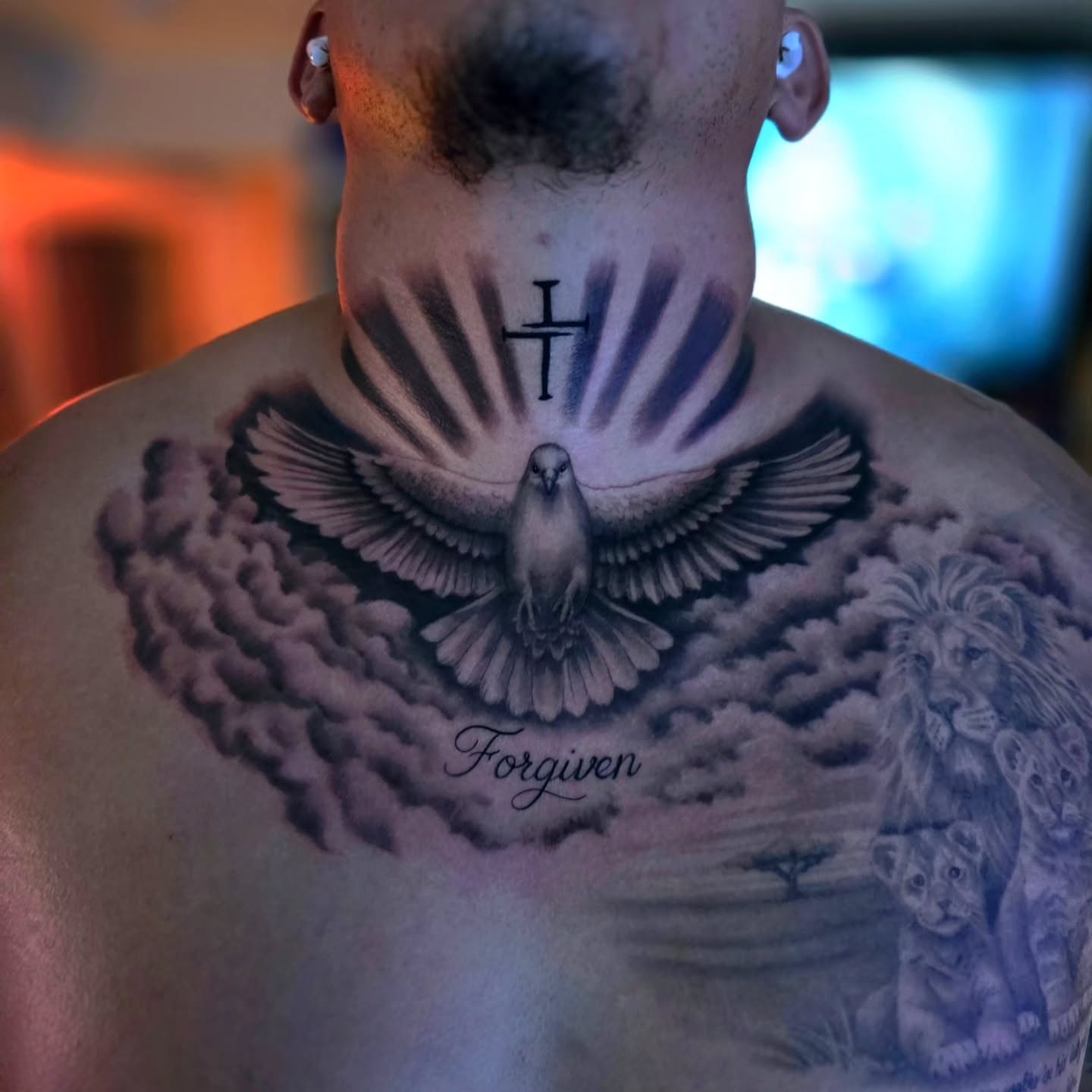 Dove and lion family realism tattoo on the chest by Luke Jordan Ink, Louisville, Colorado