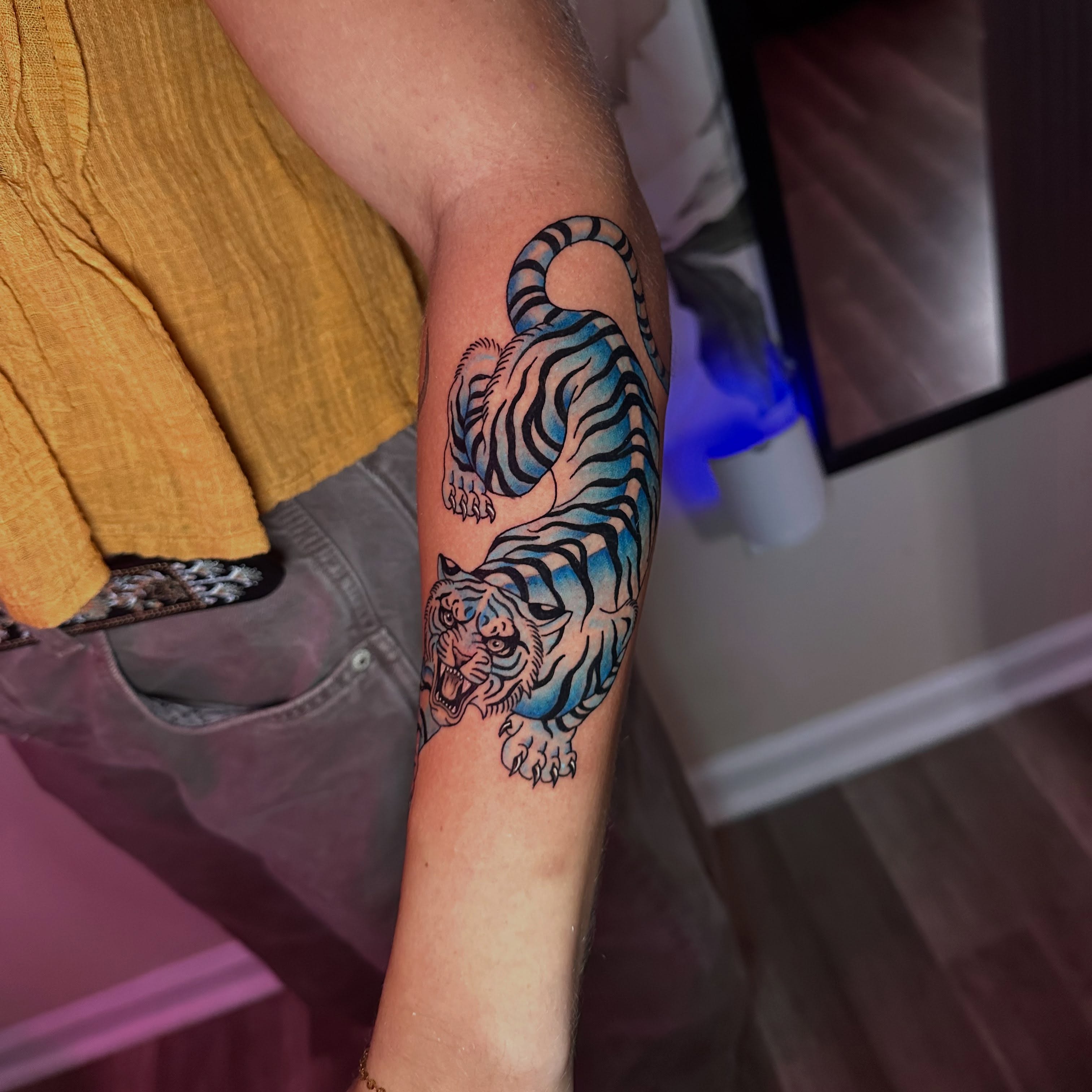 Tiger American traditional tattoo on the forearm by Diana Kunz