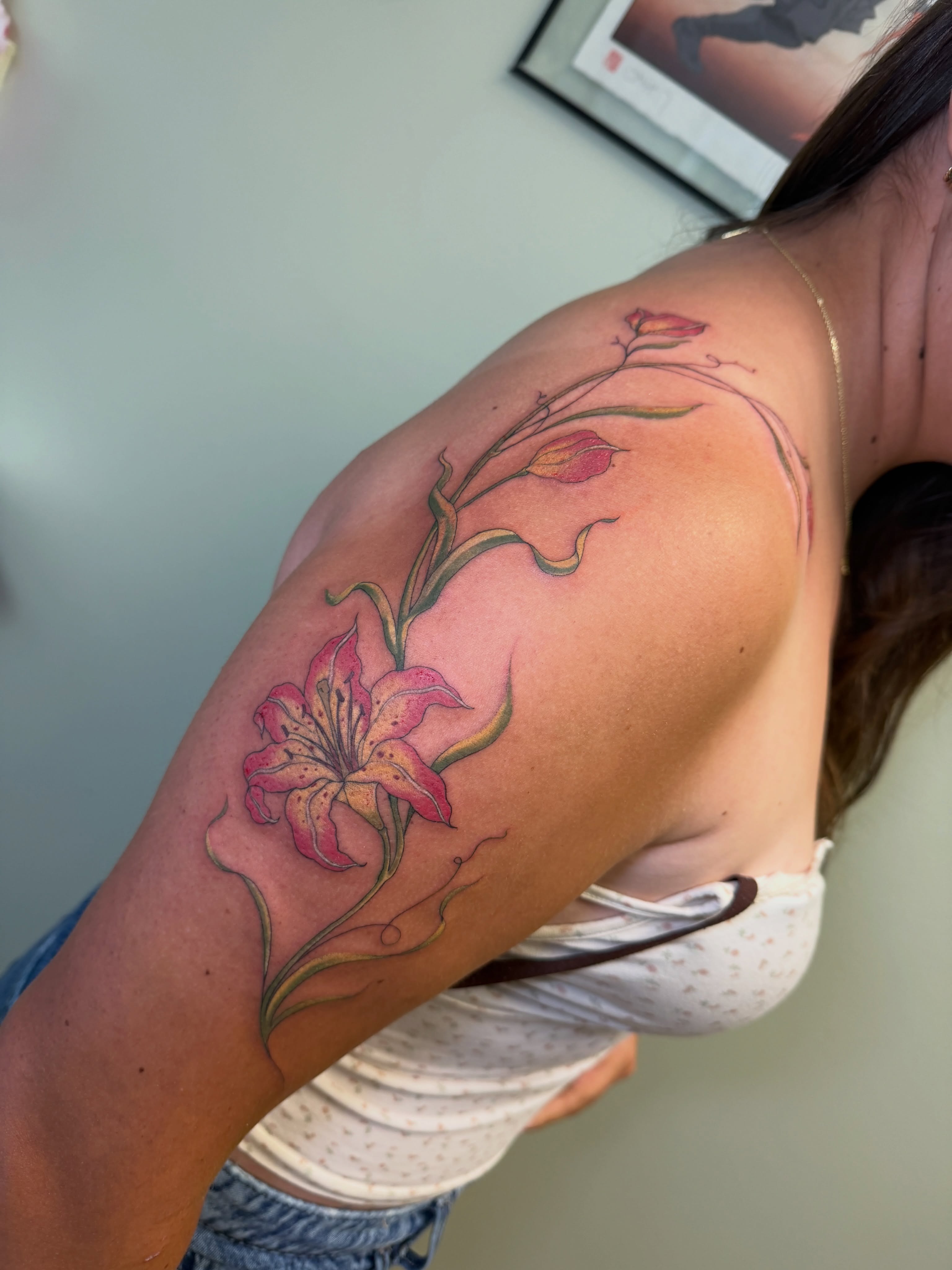 Lily realism tattoo on the shoulder by Koryn Donnelly