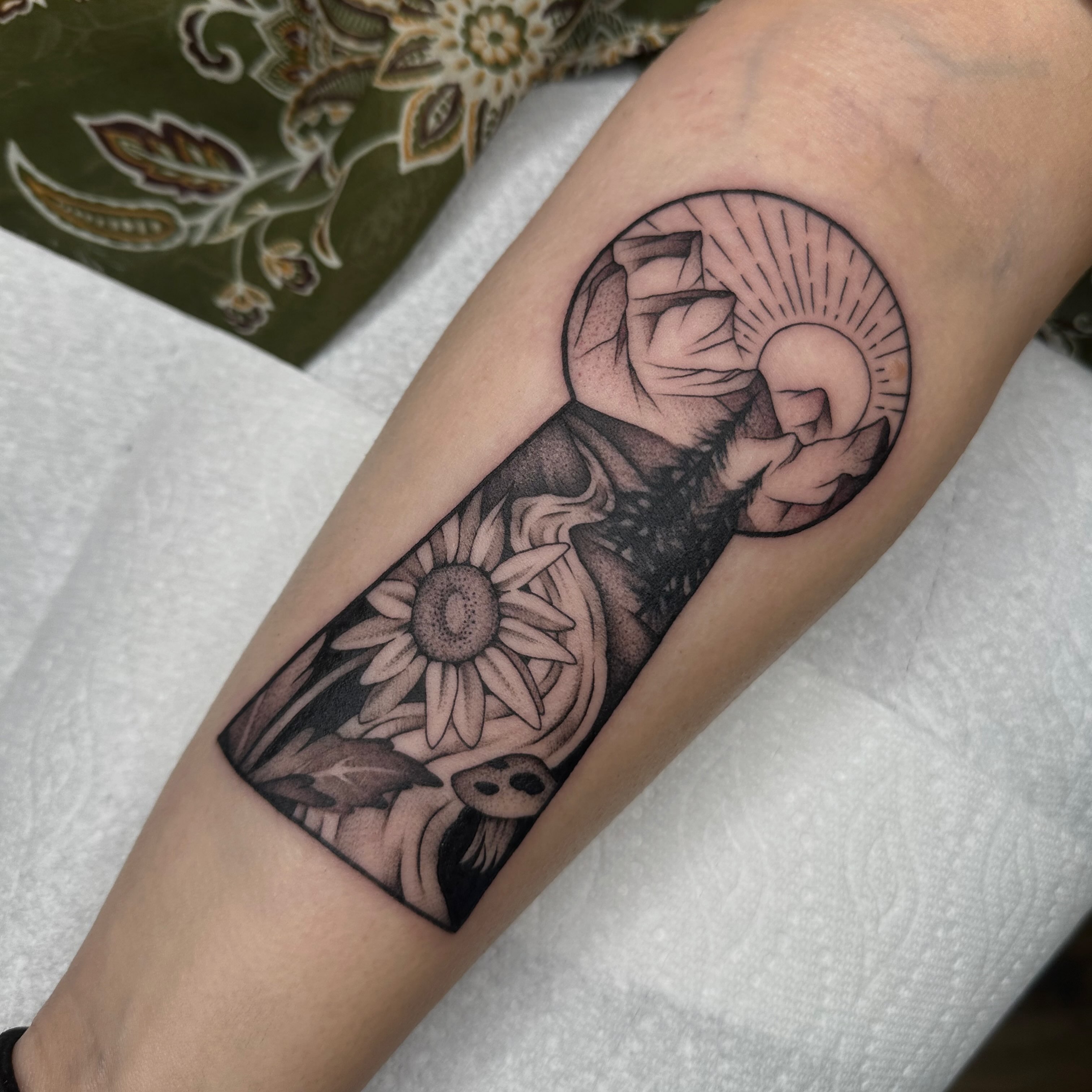 Ship and sun dotwork tattoo on the forearm by Aleksandra