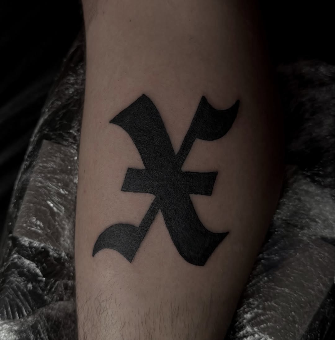 Pisces symbol black and grey tattoo on the forearm by Jordan Sandoval