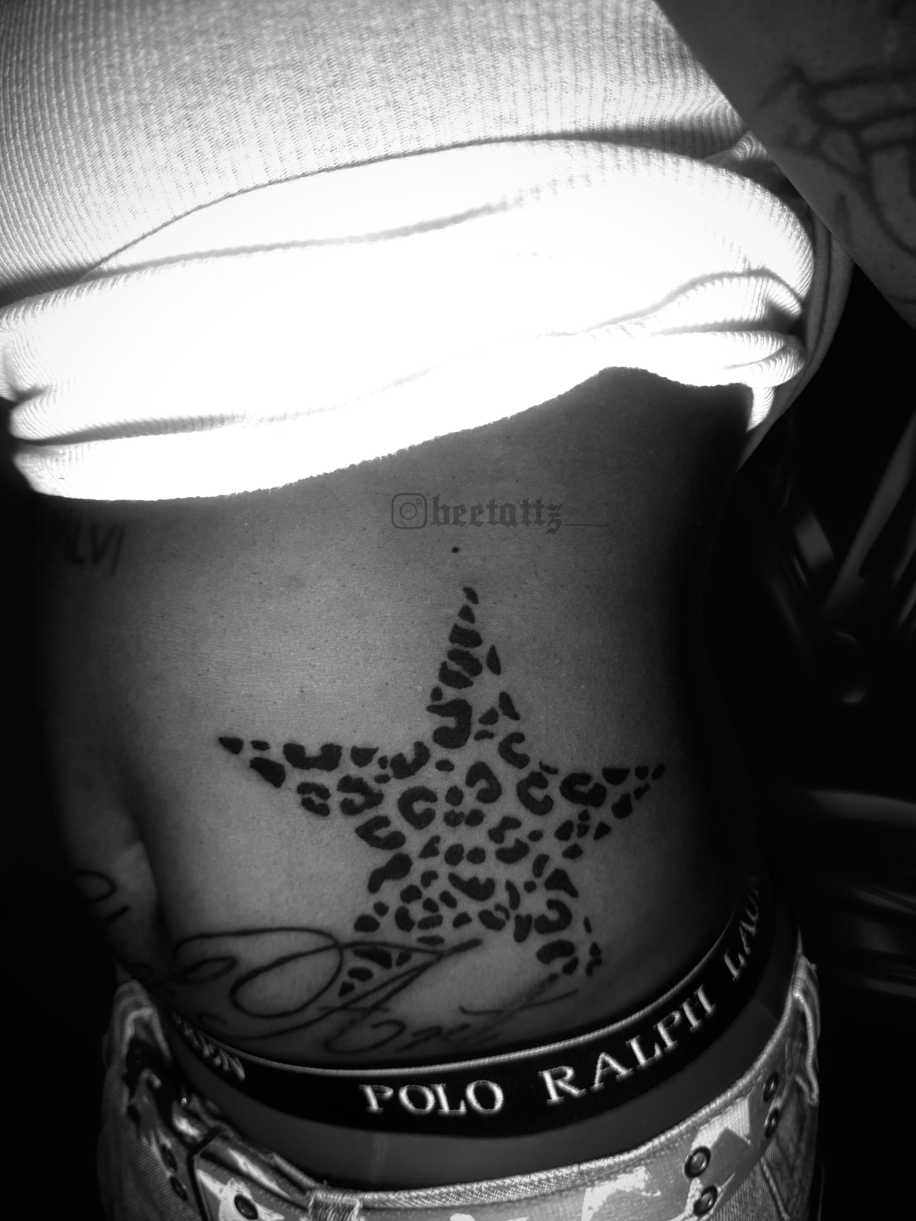 Leopard print star dotwork tattoo on the ribs by Brinkley McGill