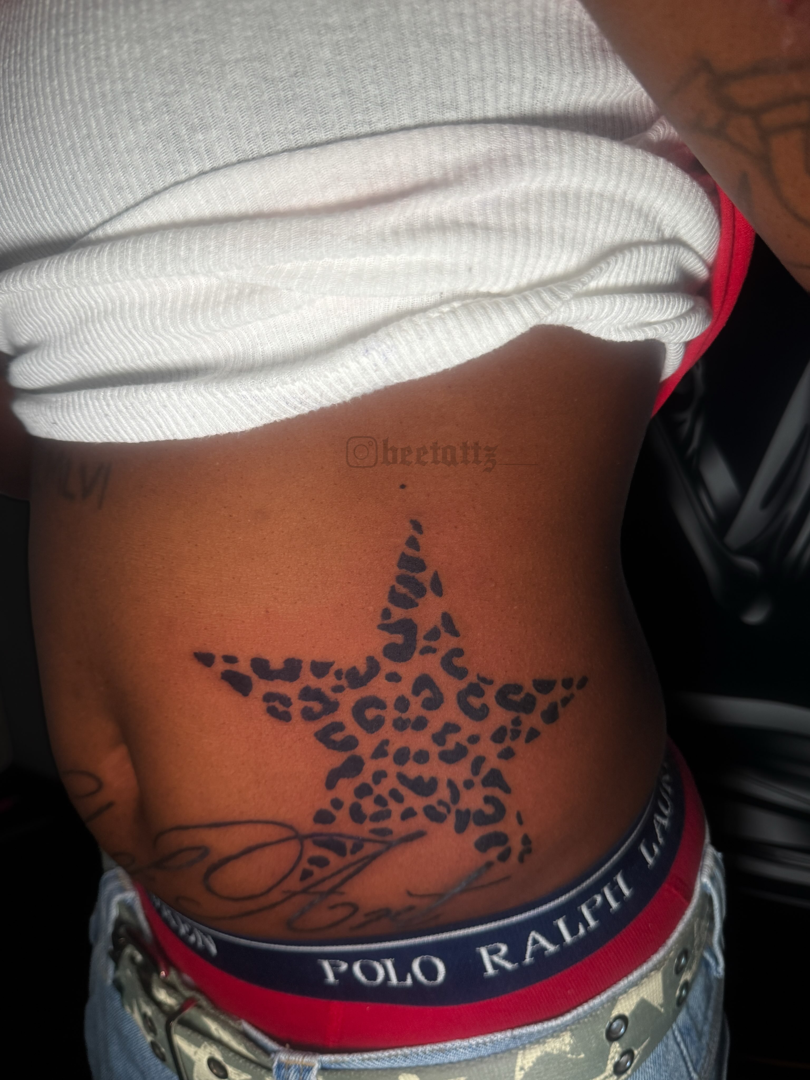 Leopard print star dotwork tattoo on the ribs by Brinkley McGill