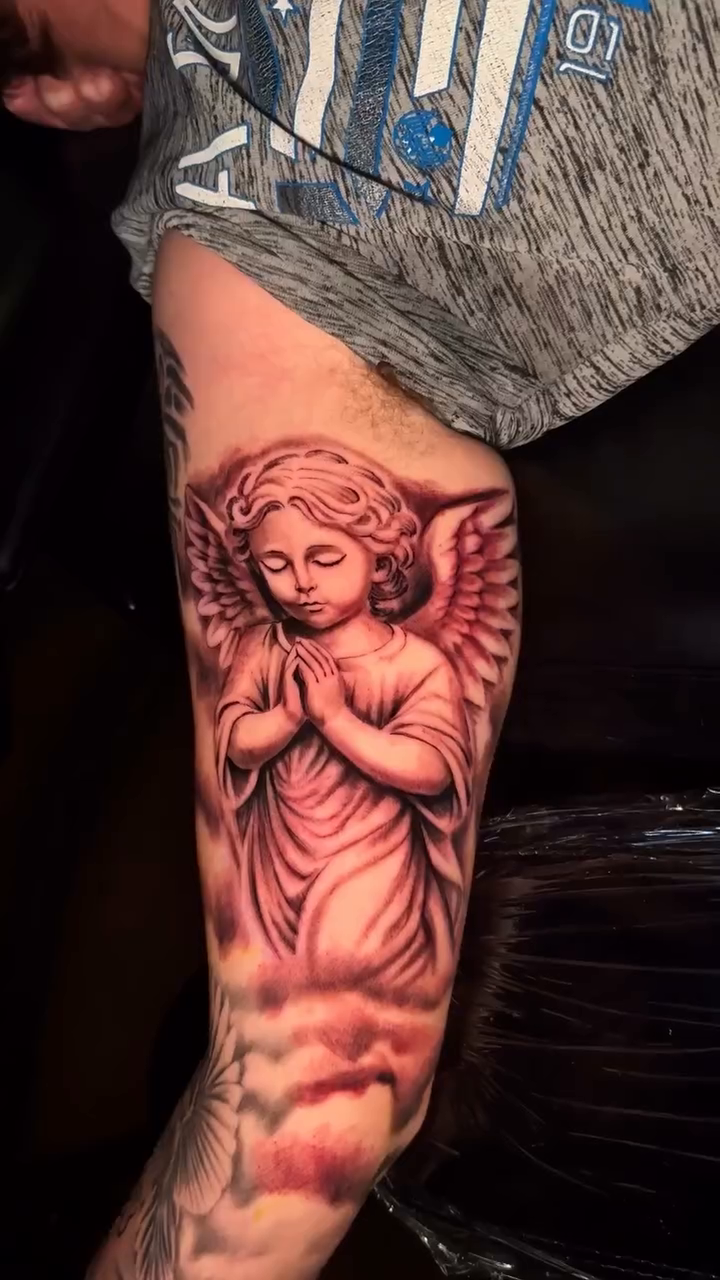 Praying angel with clouds realism tattoo by Jacob Martin, Toledo, Ohio