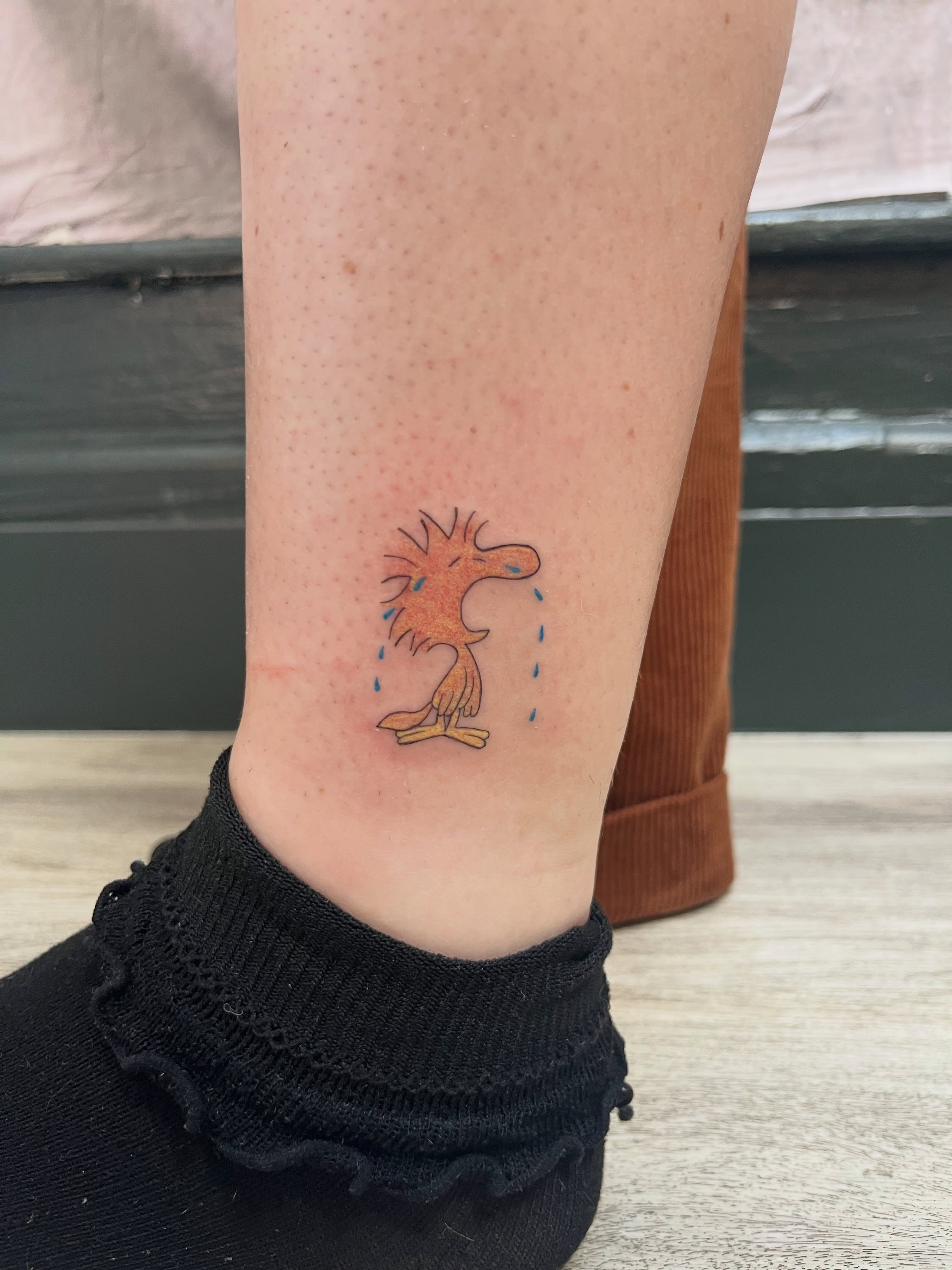 Woody woodpecker illustrative tattoo on the calf by Kyra Monterrosa