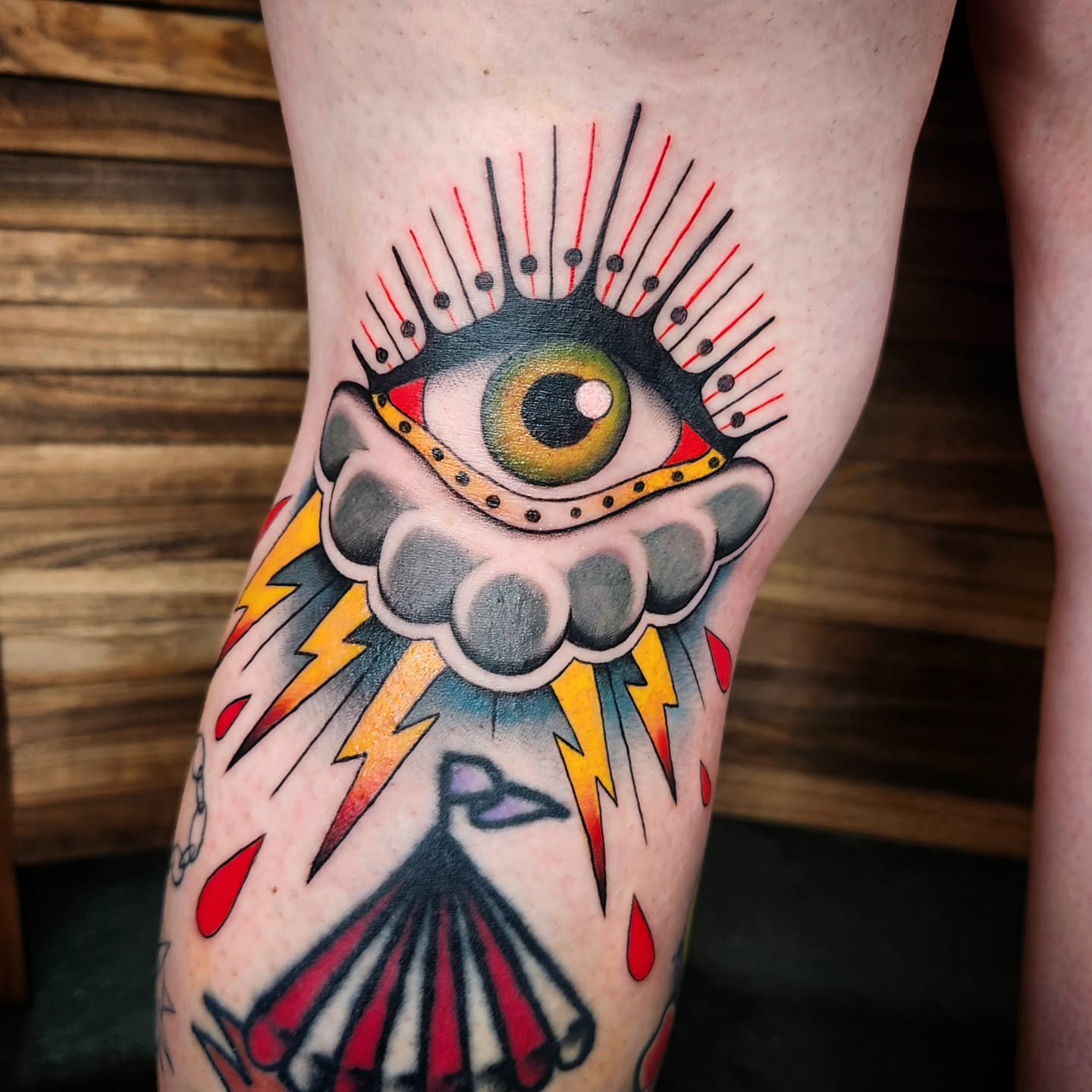 Eye with lightning bolts American traditional tattoo on the forearm by Kelly Zito
