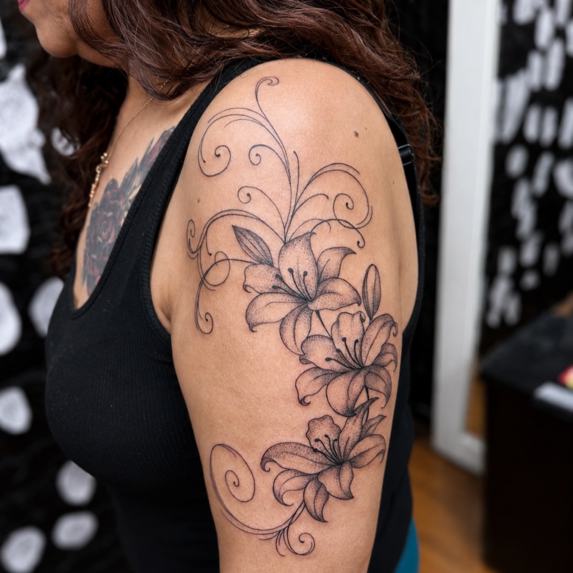 Lilies black and grey tattoo on the shoulder by Kraken ink Tattoo, San Francisco, California