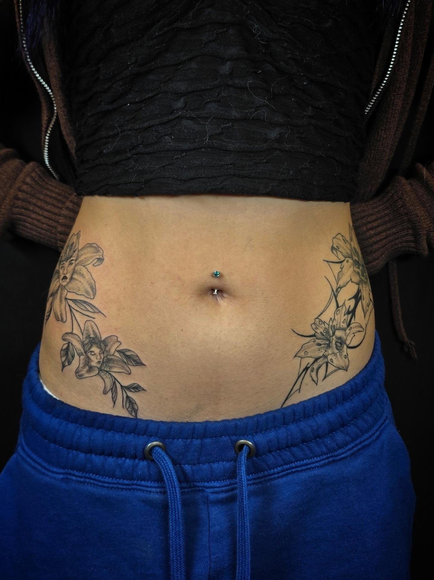 Lilies black and grey tattoo on the torso by Linda Marroum, Morningside, Maryland