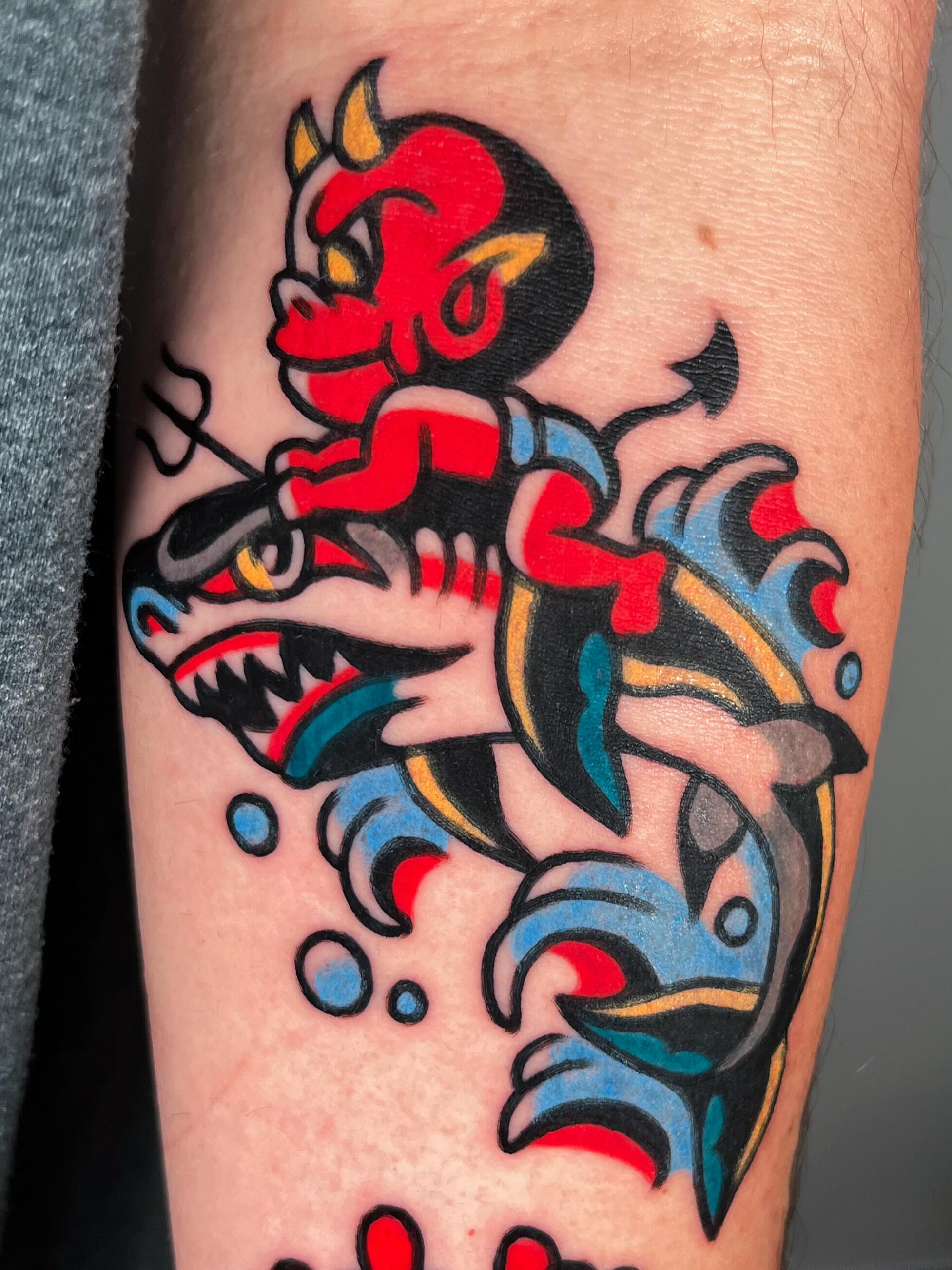 Demon riding fish American traditional tattoo on the forearm by Oldschool Tattooer Takii 타키
