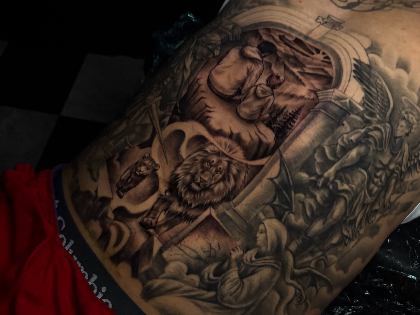 Religious scene realism tattoo on the torso by Nikko