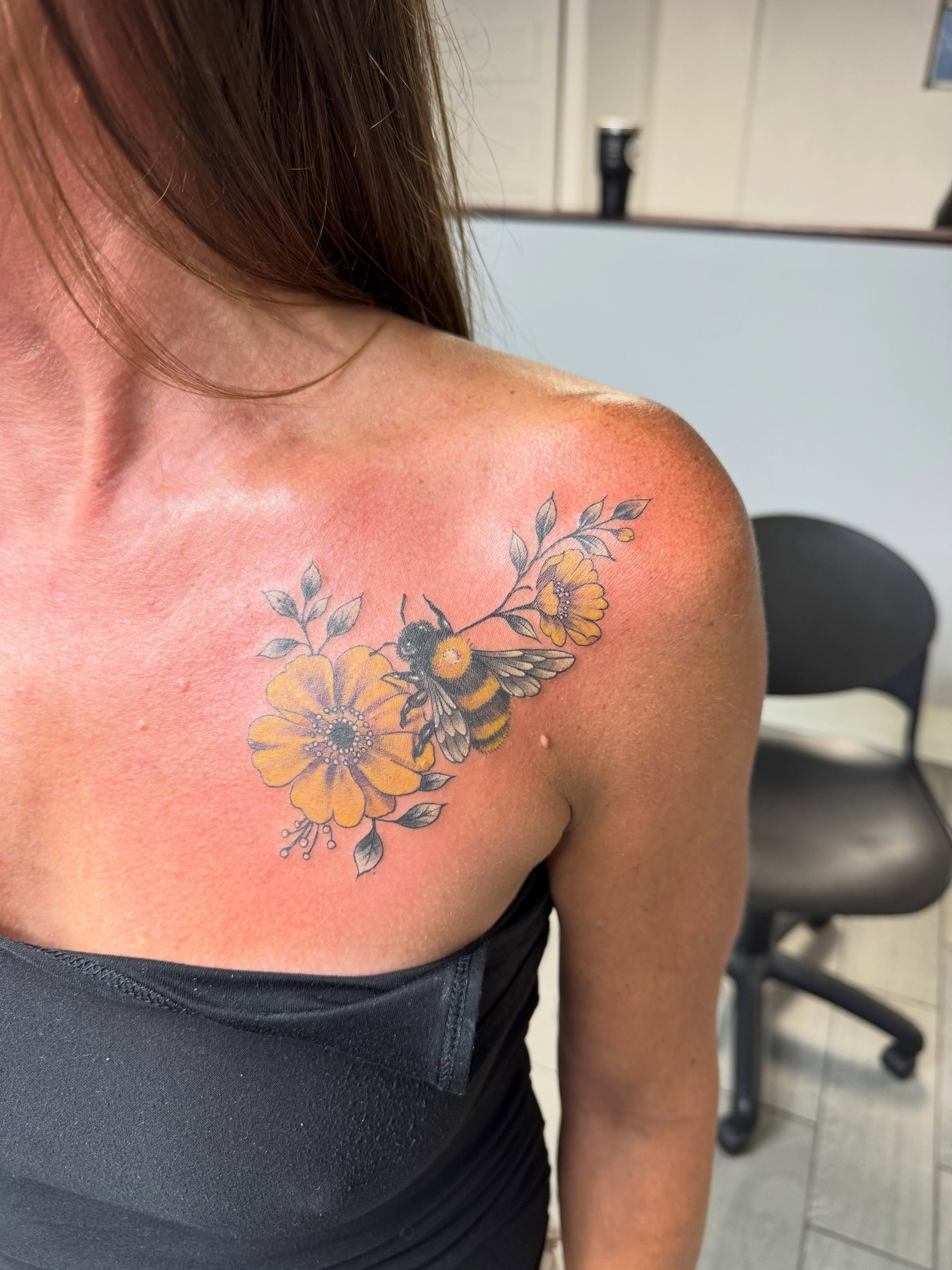 Bee and flowers neo-traditional tattoo on the shoulder by Joey Flaherty