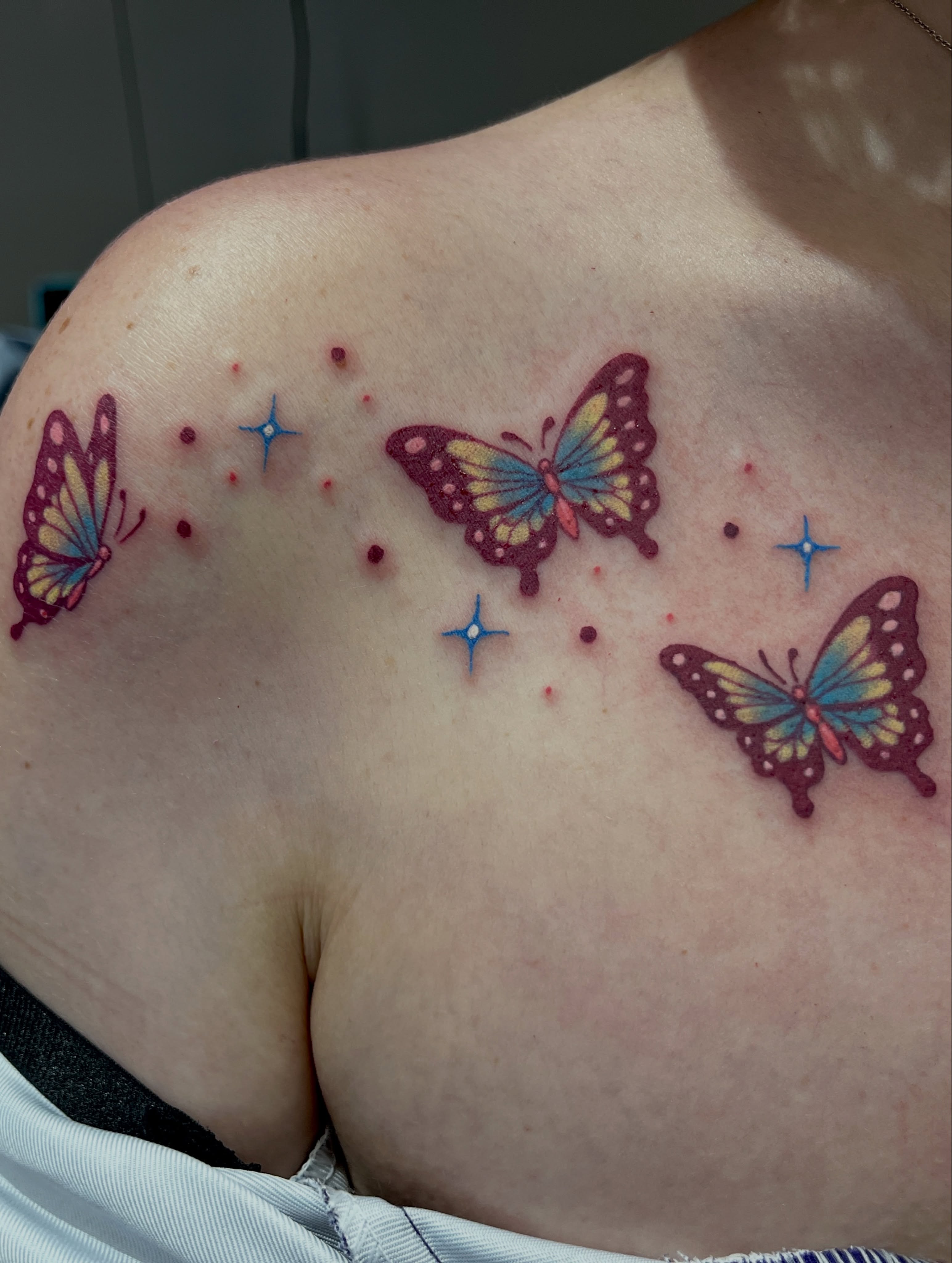 Butterflies dotwork tattoo on the chest by Cheyanne Peck