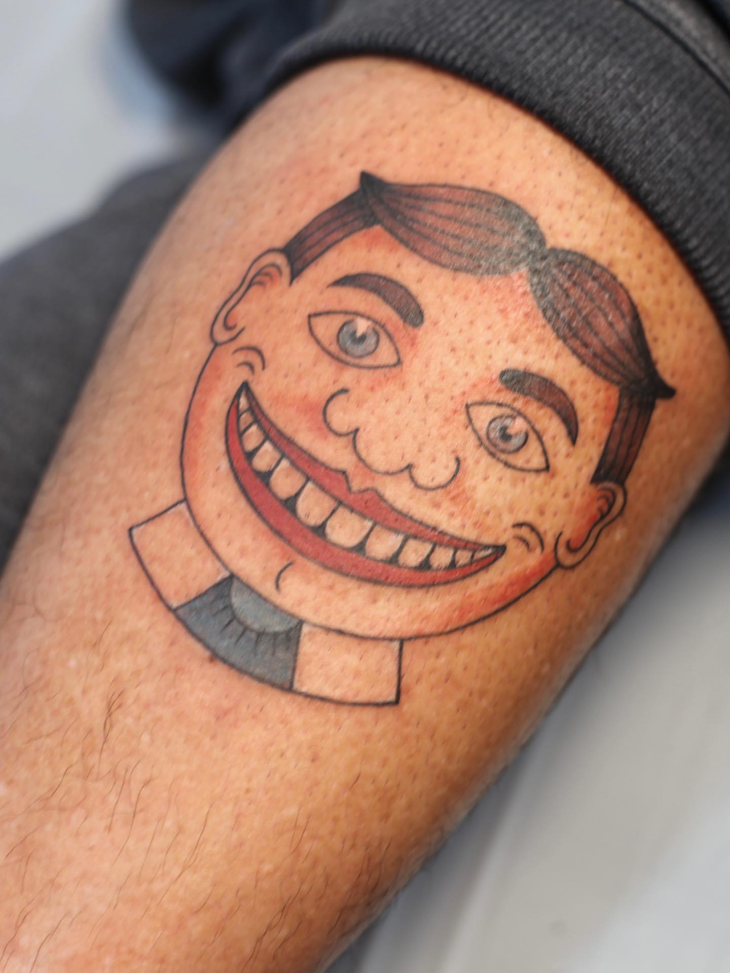 Smiling cartoon face American traditional tattoo on the forearm by adrienne mae ❀