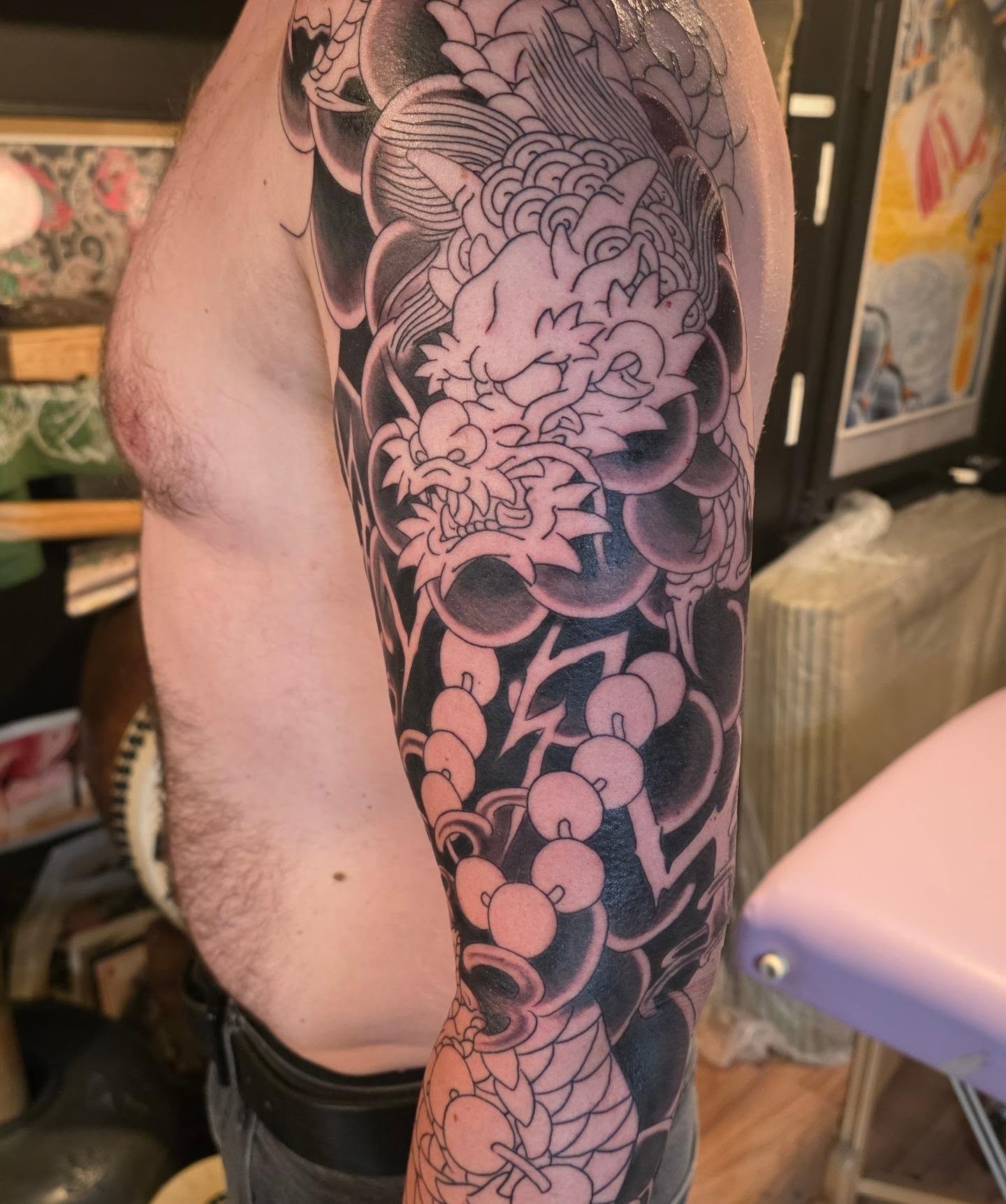 Koi fish and floral japanese irezumi tattoo on the forearm by Frank Simanton