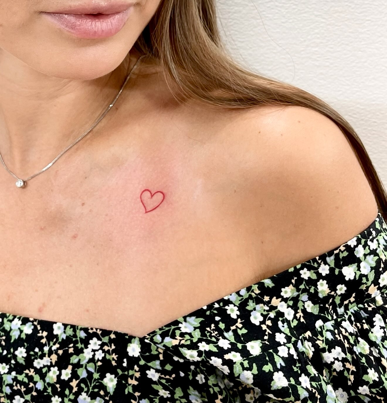 Heart fine line tattoo on the chest by Fine Line Tattoo Artist