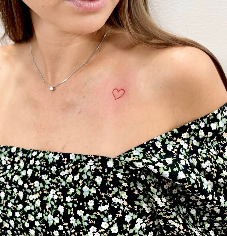 Heart fine line tattoo on the chest by Fine Line Tattoo Artist