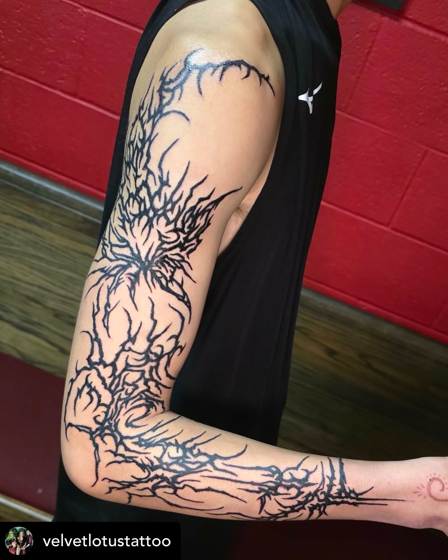 Abstract plant black and grey tattoo on the forearm by Michelle Balhan
