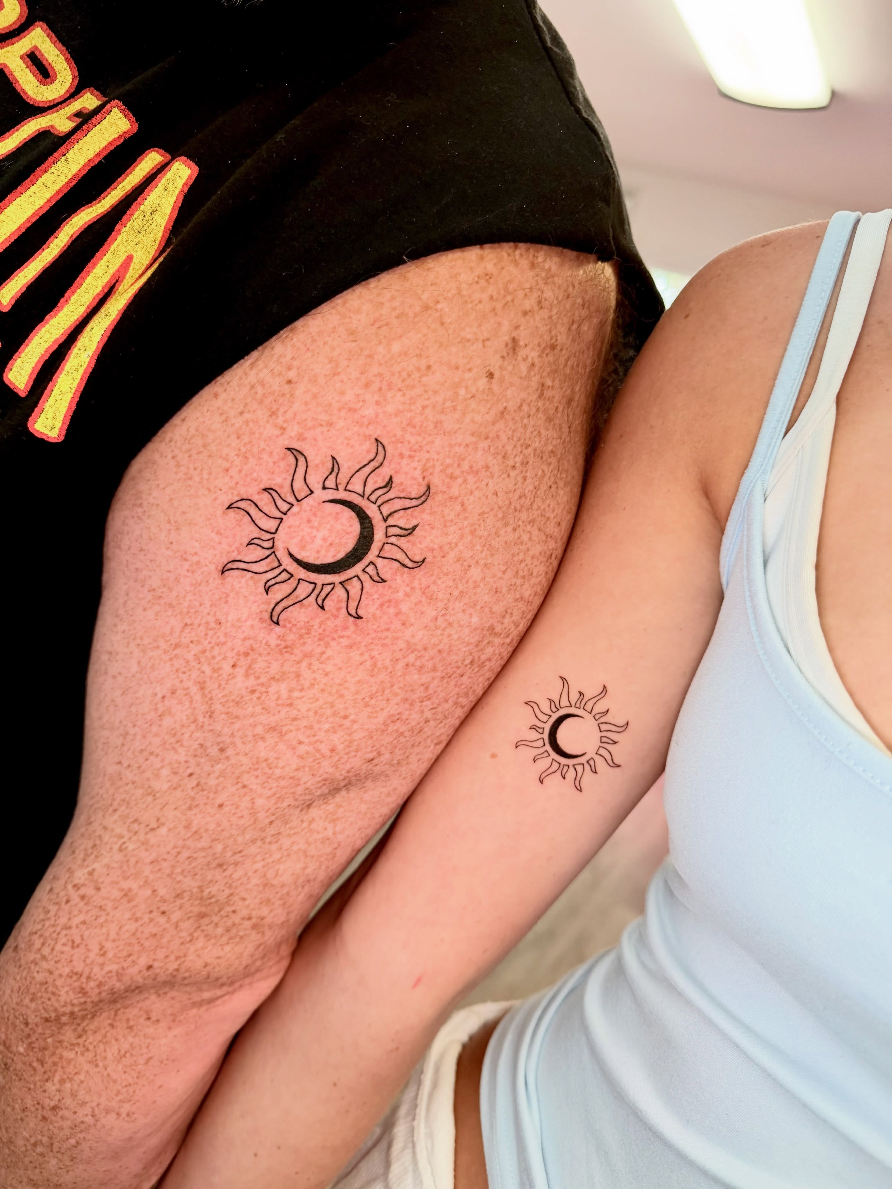 Sun and moon minimalist tattoo on the thigh by Fine Line Tattoo Artist