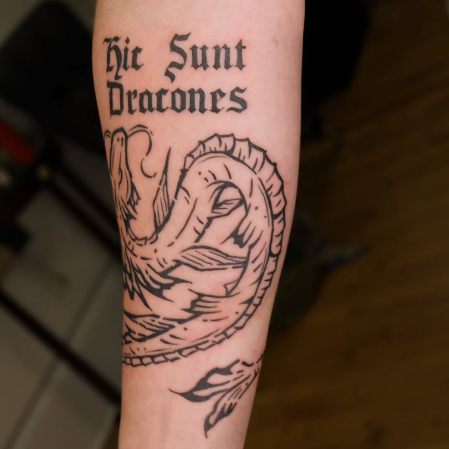 Dragon black and grey tattoo on the forearm by Veronika Lipchak