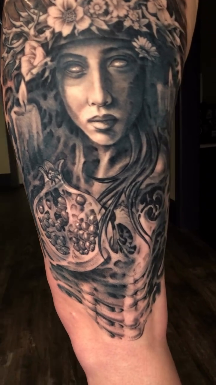 Woman with floral crown and pomegranates realism tattoo by Oak Adams
