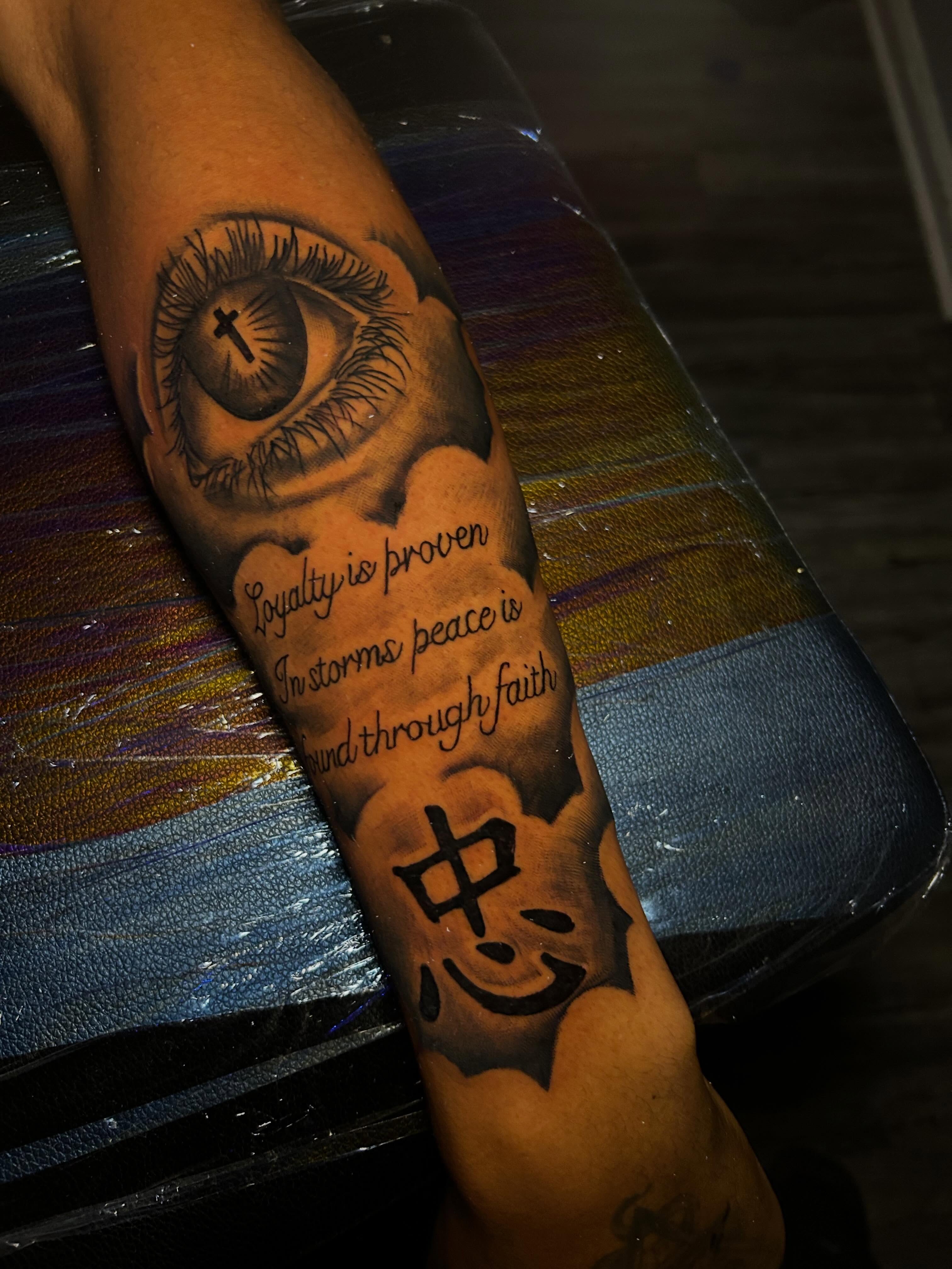 Eye with cross realism tattoo on the forearm by Ferlandis Fitch, Long Beach, California