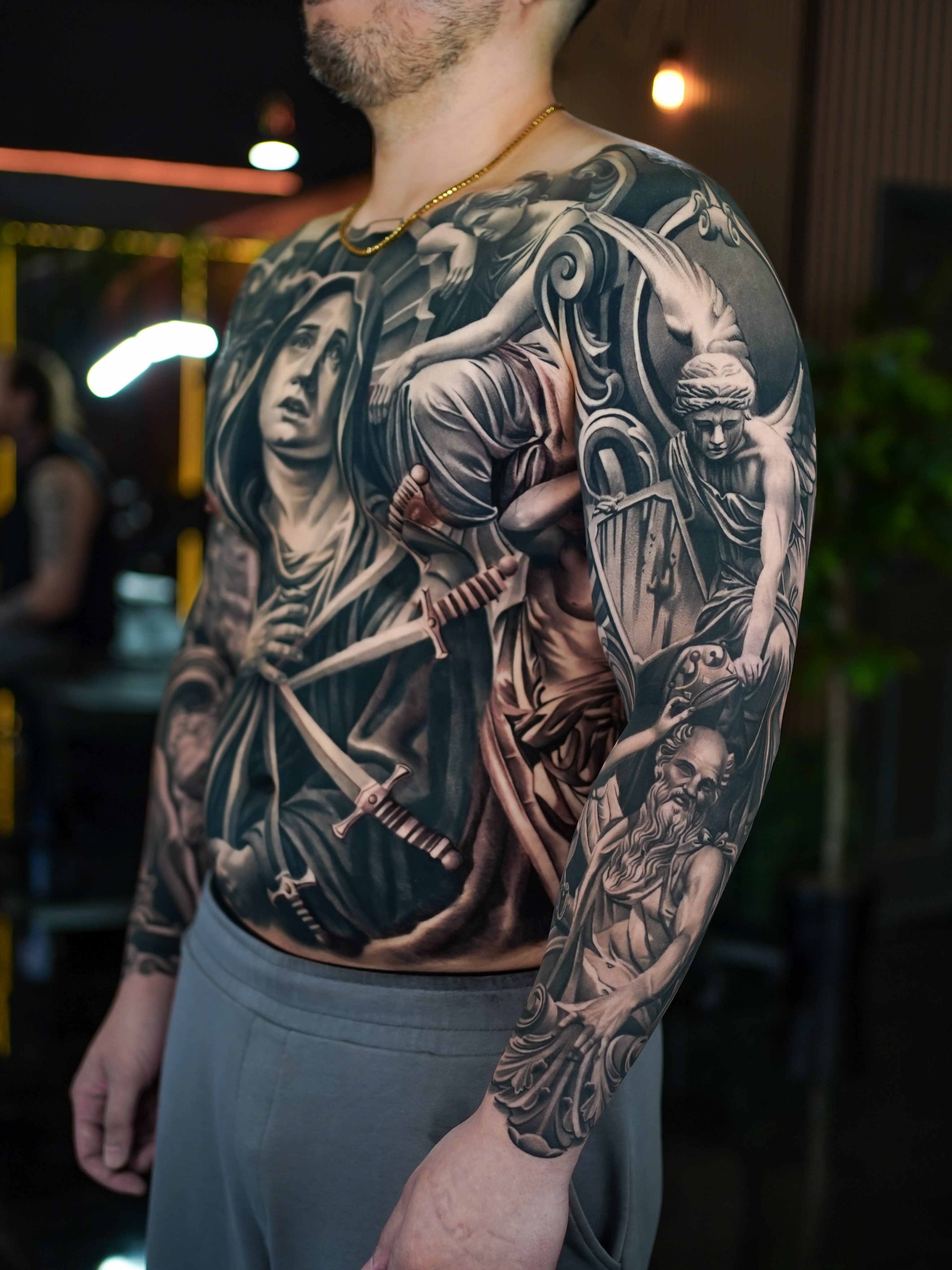 Religious figures realism tattoo on the torso by Fábio Guerreiro