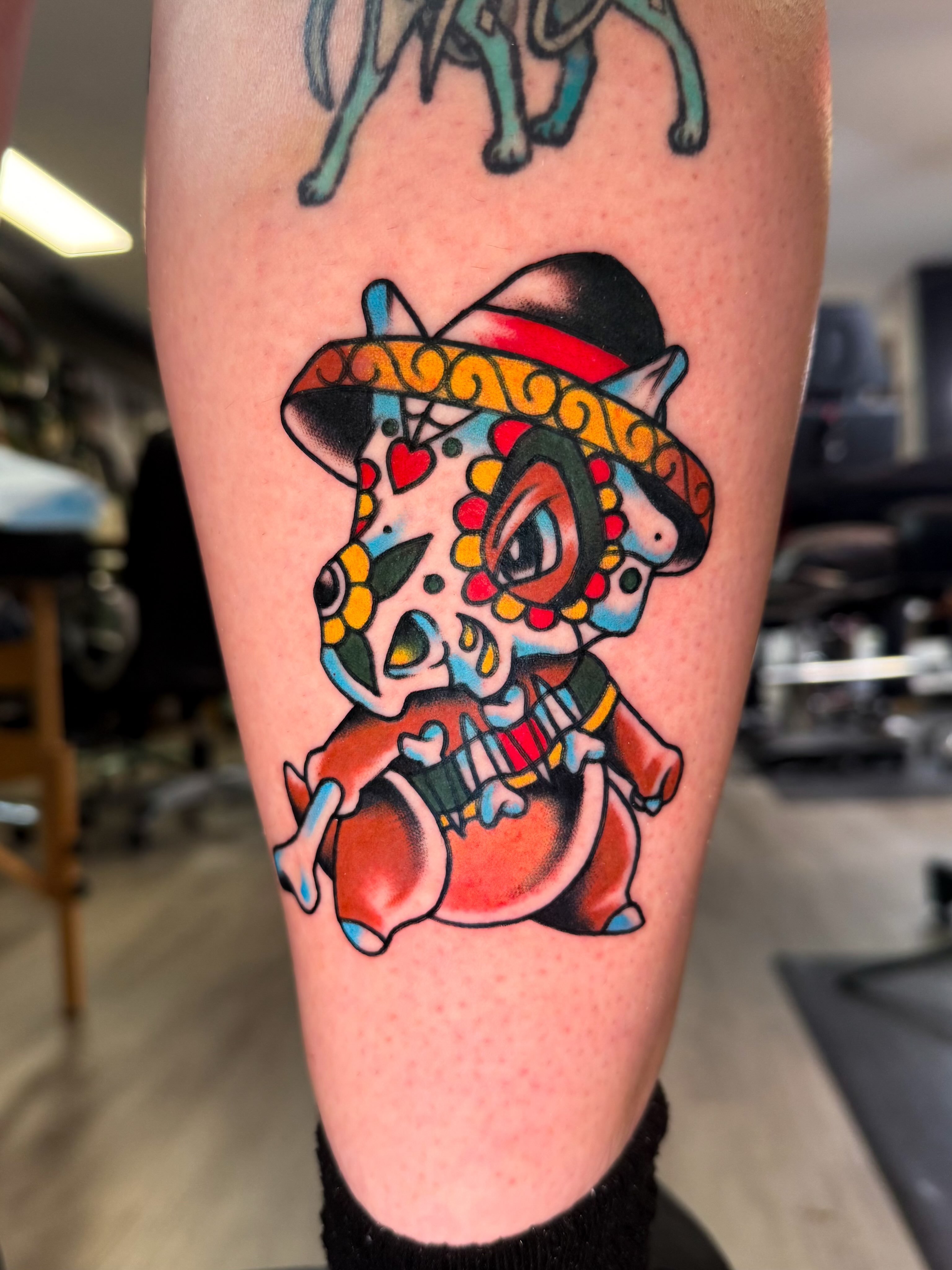 Cat skull with sombrero American traditional tattoo on the forearm by Louie Flores